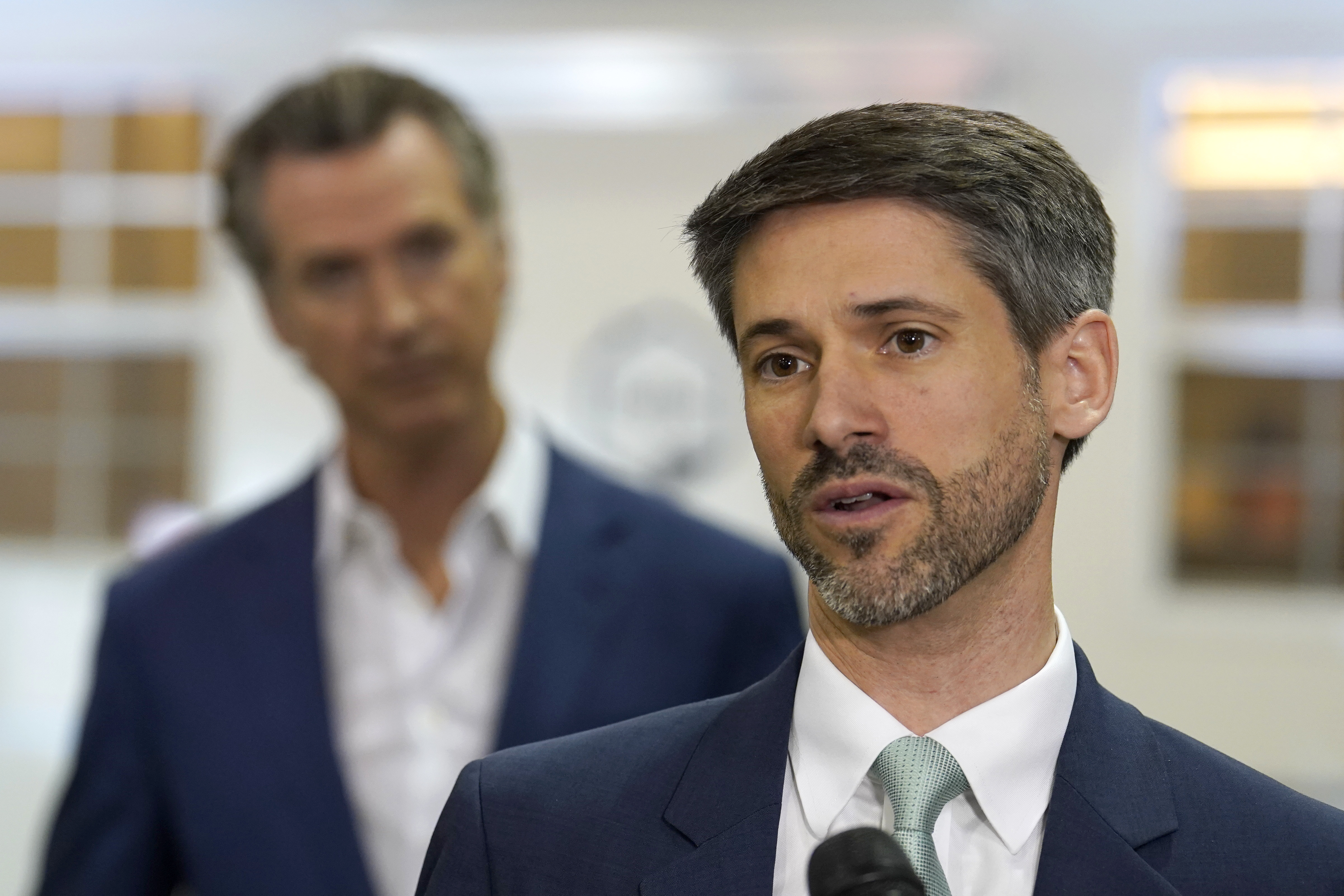 FILE - San Jose Mayor Matt Mahan, right, discusses California Gov. Gavin Newsom's, left, proposal to build 1,200 small homes across the state to reduce homelessness, during the first of a four-day tour of the state in Sacramento Calif., Thursday, March 16, 2023. (AP Photo/Rich Pedroncelli, File)