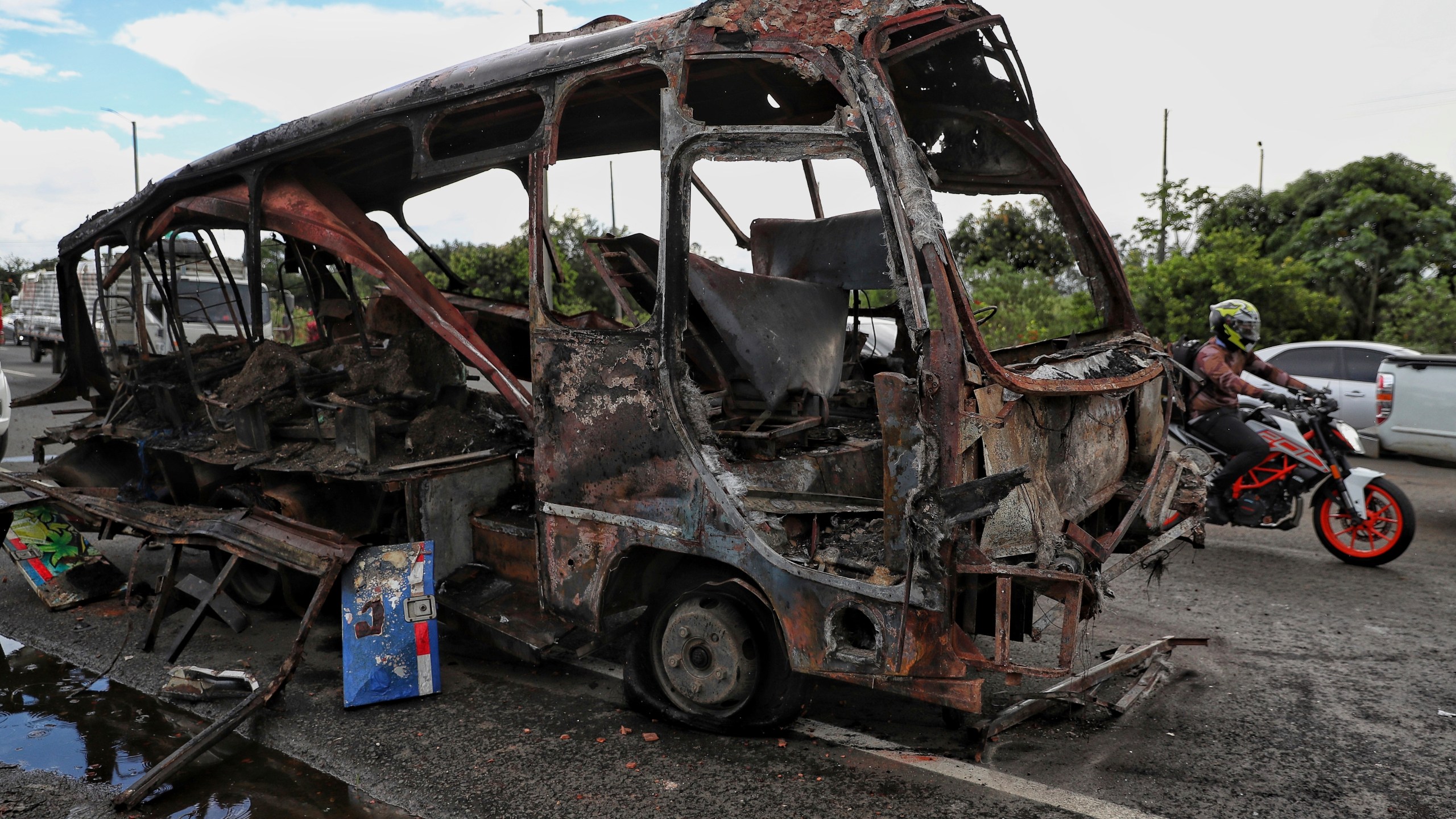 A bus that exploded next to a police station sits on a road in Villa Rica, Cauca Valley, Colombia, Tuesday, June 10, 2025. (AP Photo/Santiago Saldarriaga)