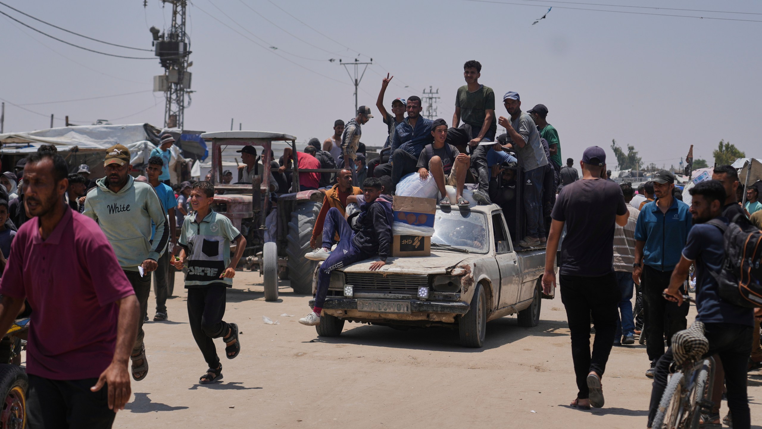 Palestinians carry food and humanitarian aid packages delivered by the Gaza Humanitarian Foundation, a U.S.-backed organization, in Rafah, southern Gaza Strip, Tuesday, June 10, 2025. (AP Photo/Abdel Kareem Hana)