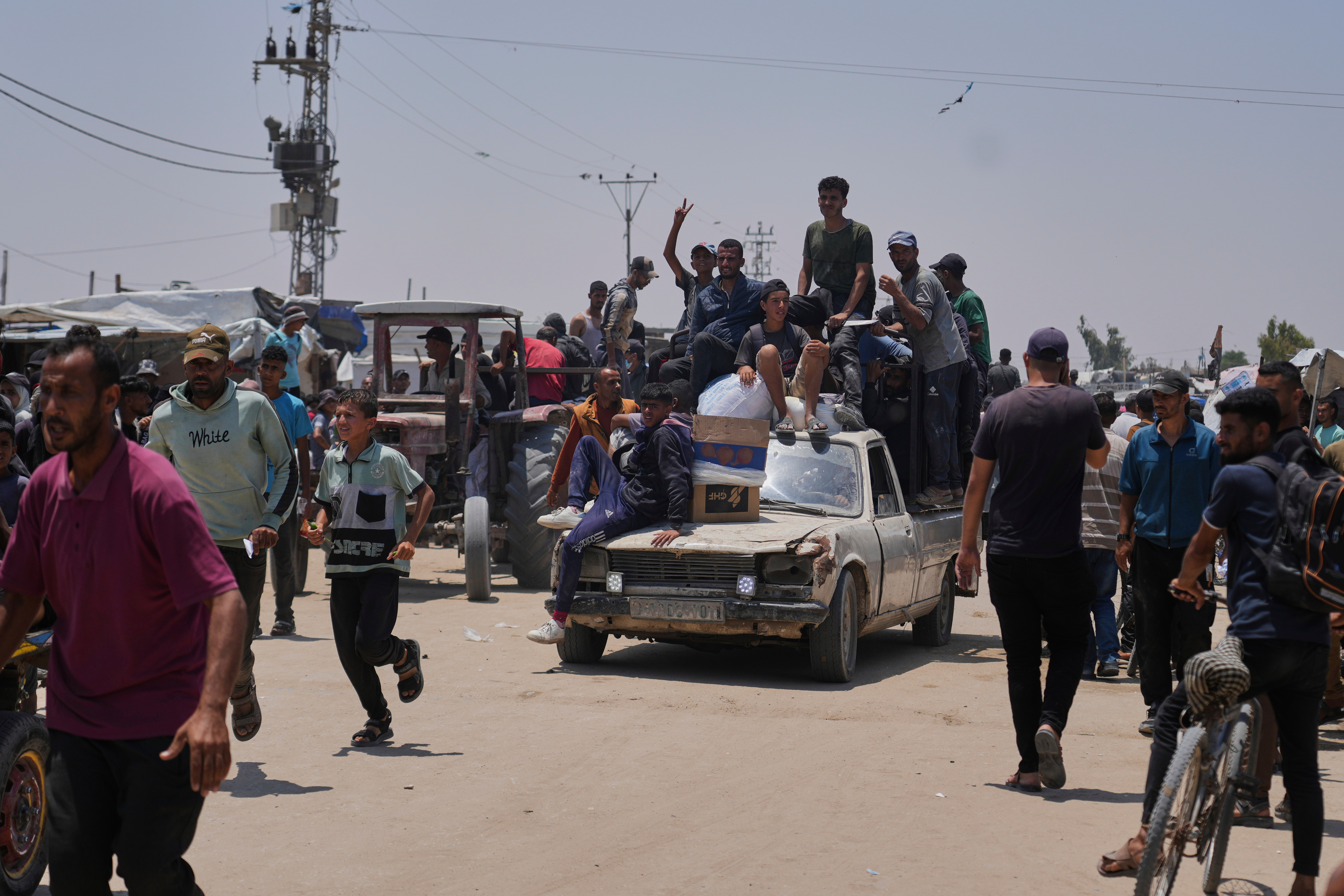 Palestinians carry food and humanitarian aid packages delivered by the Gaza Humanitarian Foundation, a U.S.-backed organization, in Rafah, southern Gaza Strip, Tuesday, June 10, 2025. (AP Photo/Abdel Kareem Hana)