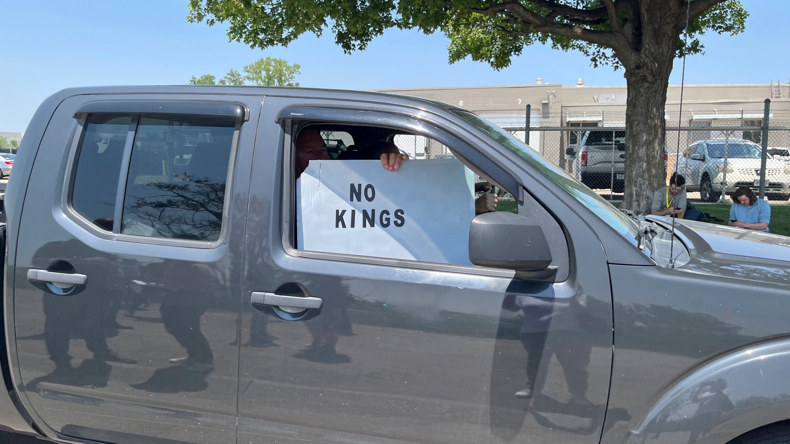 A person holds a sign outside of Glenn Valley Foods, a meat packaging company that was raided by U.S. Immigration and Customs Enforcement on Tuesday, June 10, 2025, in Omaha, Neb. (AP Photo/Margery A. Beck)