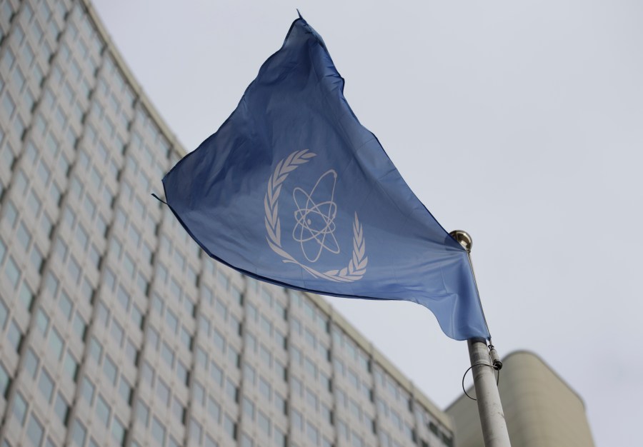 FILE - The flag of the International Atomic Energy Agency flys in front of its headquarters during an IAEA Board of Governors meeting in Vienna, Austria, Feb. 6, 2023. (AP Photo/Heinz-Peter Bader, File)