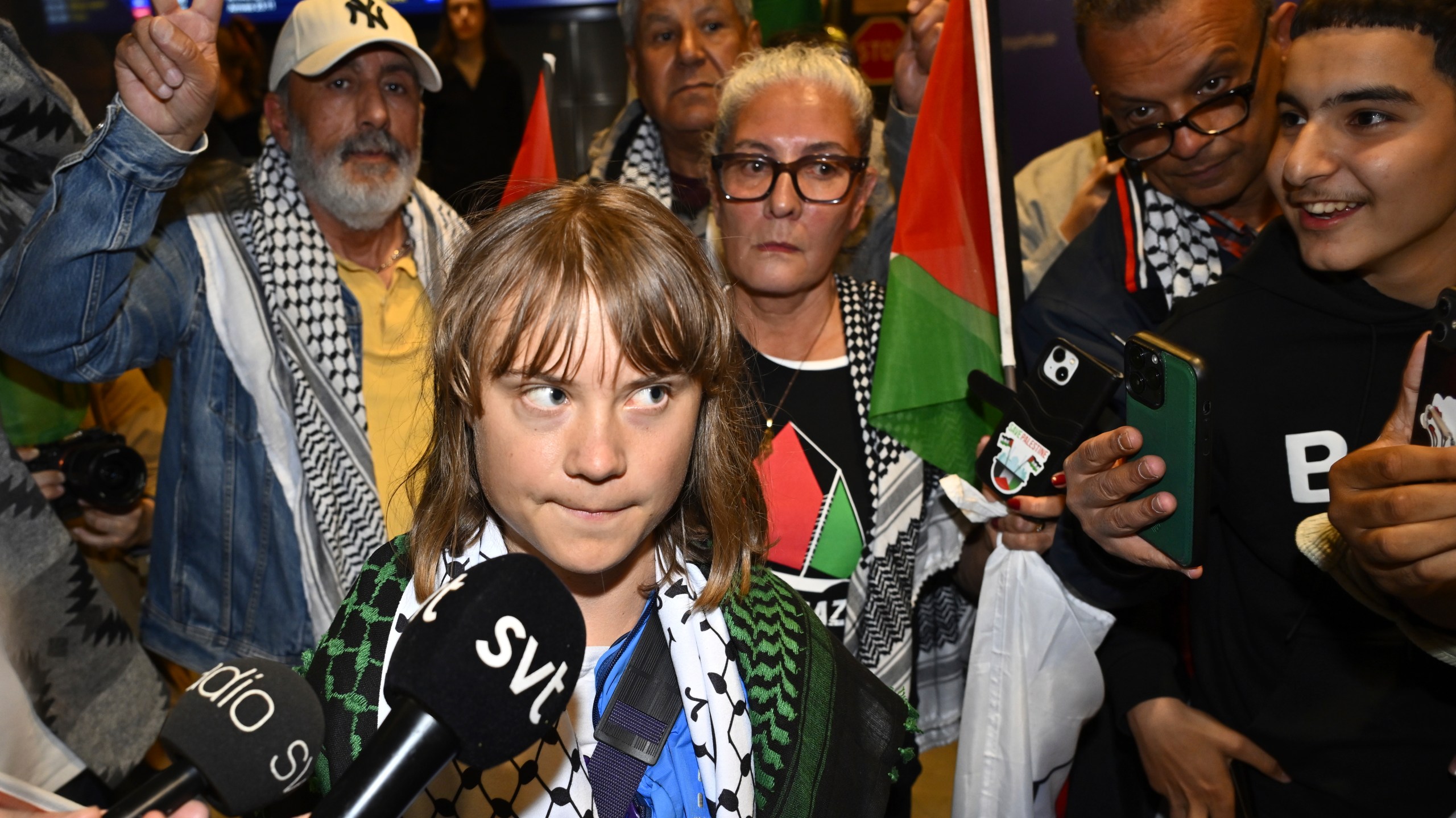 Swedish activist Greta Thunberg talks to journalists as she arrives at Stockholm Arlanda Airport outside Stockholm, Sweden, Tuesday June 10, 2025. (Anders Wiklund/TT News Agency via AP)