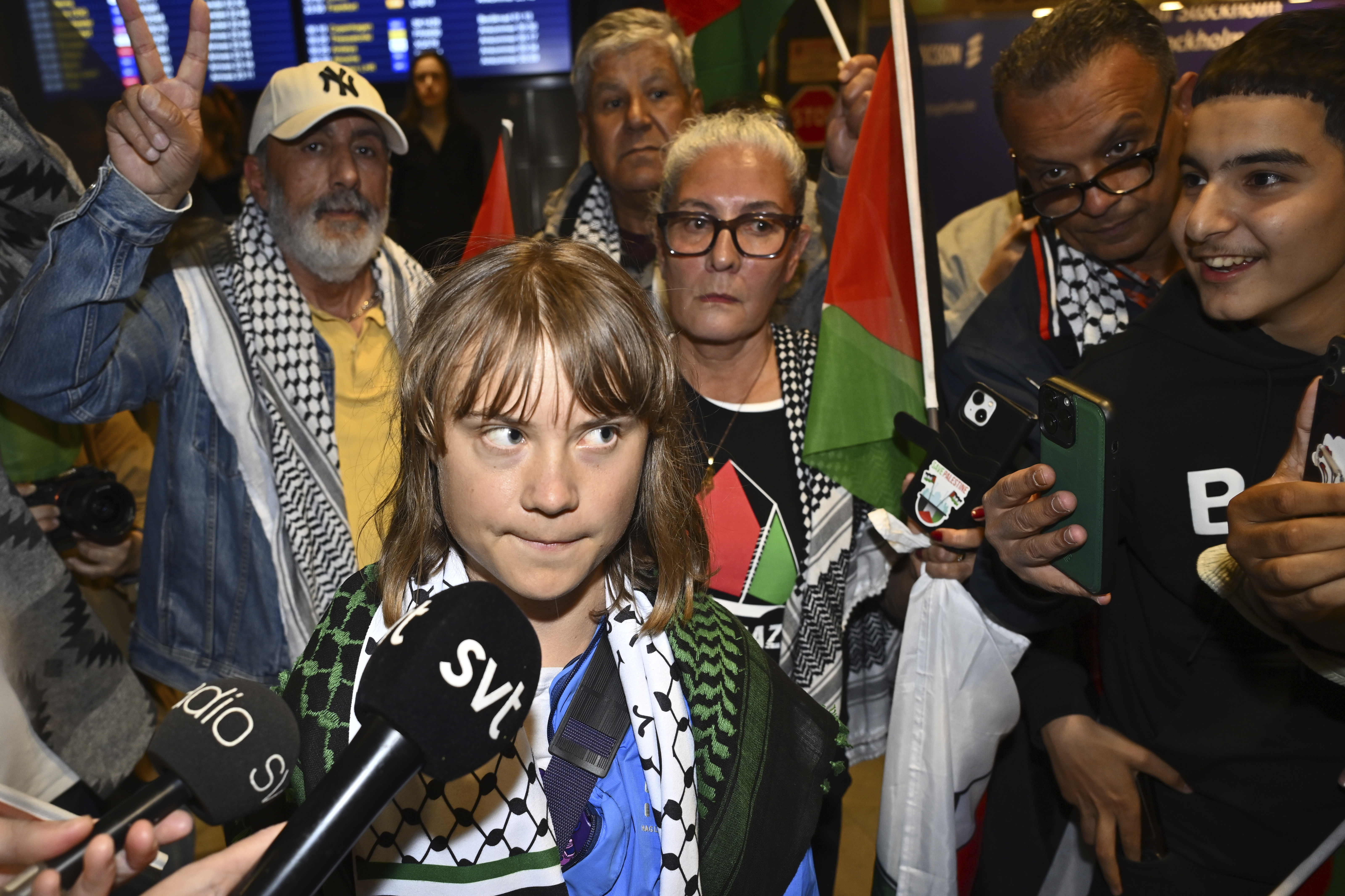 Swedish activist Greta Thunberg talks to journalists as she arrives at Stockholm Arlanda Airport outside Stockholm, Sweden, Tuesday June 10, 2025. (Anders Wiklund/TT News Agency via AP)