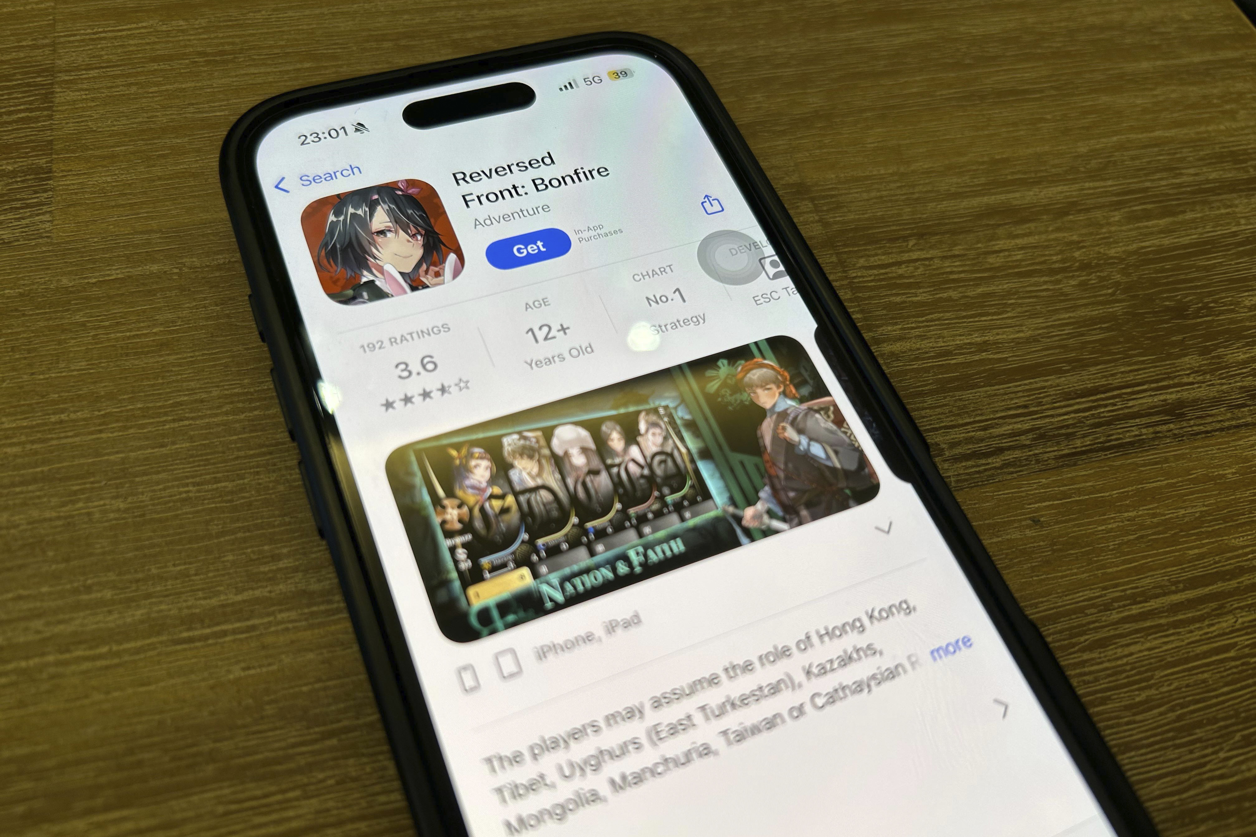 A phone shows the an App Store page for the application "Reversed Front: Bonfire," In Hong Kong, Tuesday, June 10, 2025. (AP Photo)
