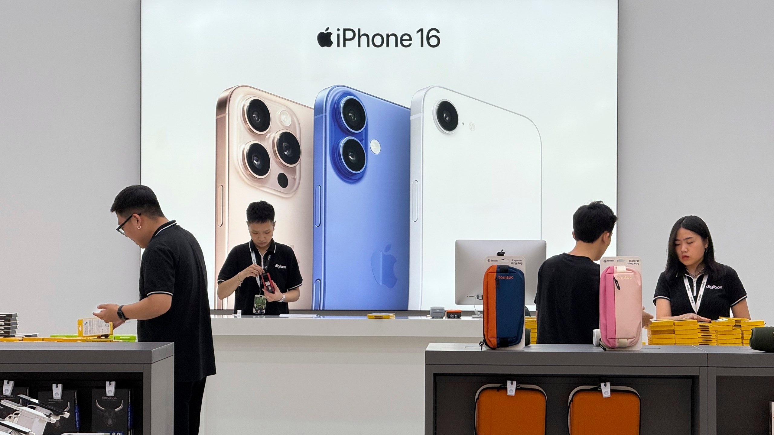FILE - Sales staffs work at an Apple shop in Hanoi, Vietnam Thursday, April 10, 2025. (AP Photo/Hau Dinh, File)