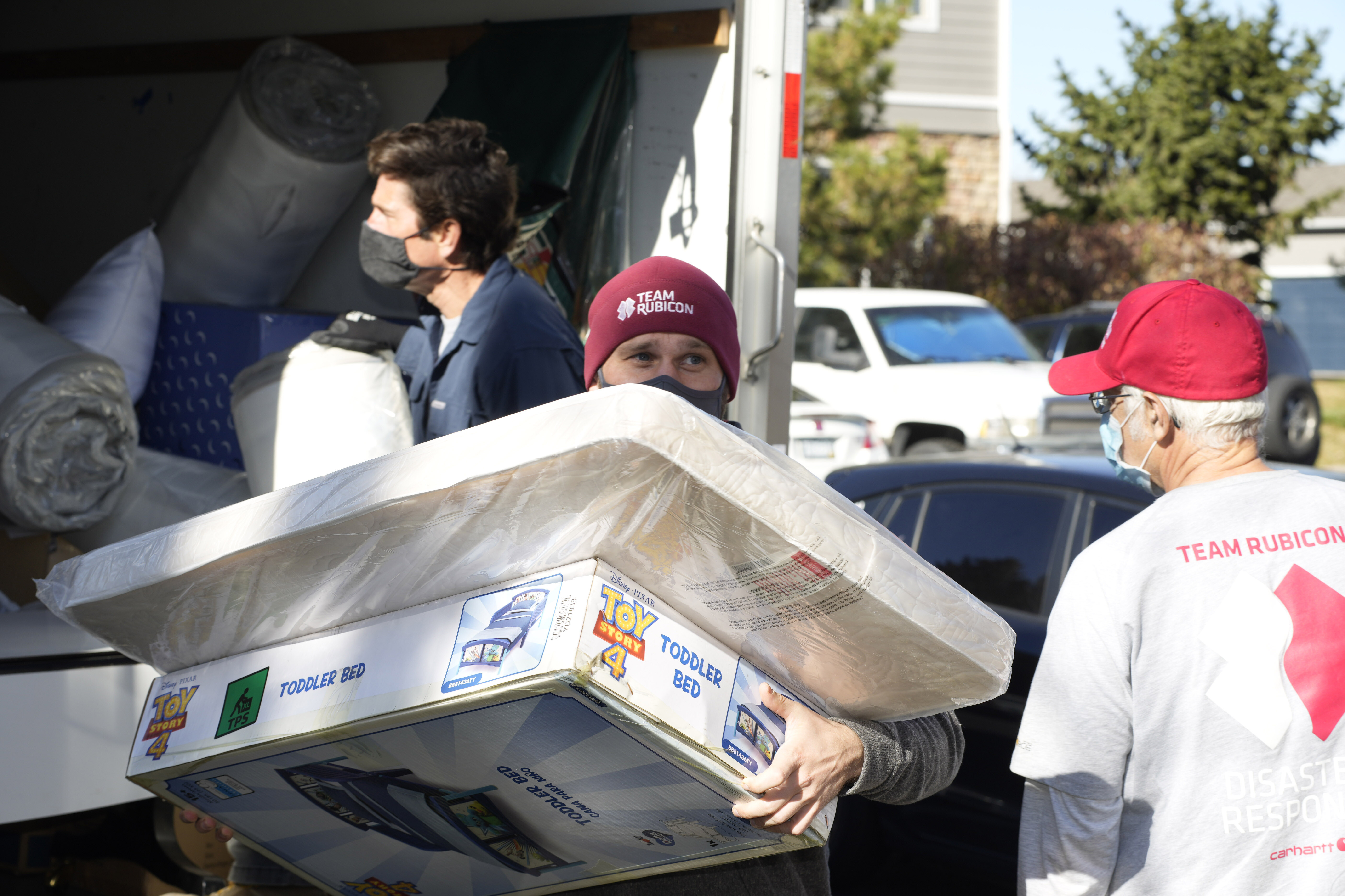 FILE - Team Rubicon volunteer Nicholas Duchnowski of Broomfield, Colo., moves belongings into an apartment that will be home to Afghan refugees, in the north Denver suburb of Thornton, Colo., Nov. 10, 2021. (AP Photo/David Zalubowski, Filepronto)