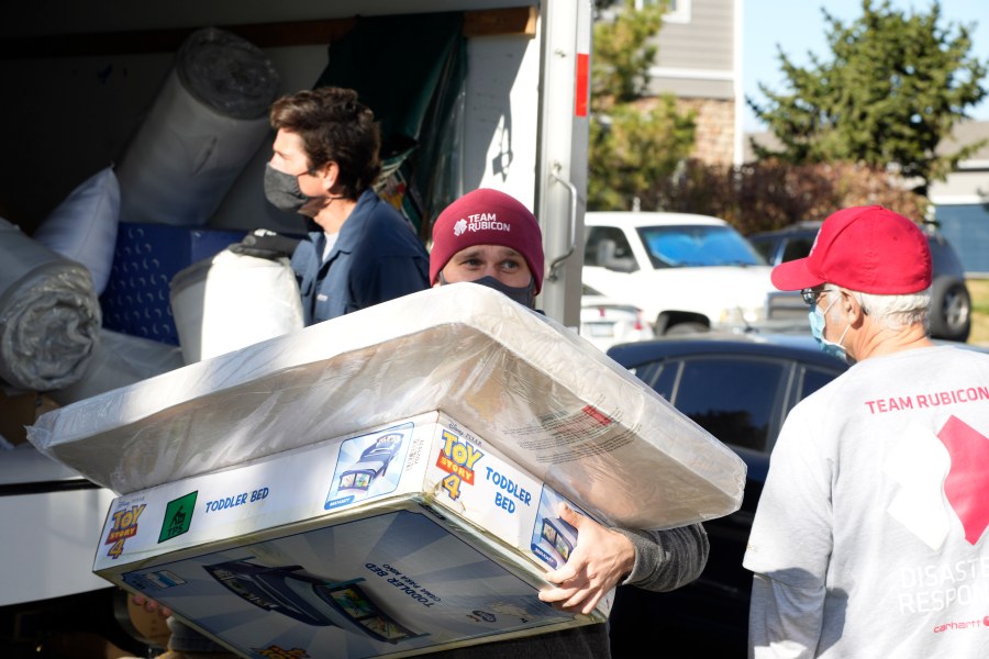 FILE - Team Rubicon volunteer Nicholas Duchnowski of Broomfield, Colo., moves belongings into an apartment that will be home to Afghan refugees, in the north Denver suburb of Thornton, Colo., Nov. 10, 2021. (AP Photo/David Zalubowski, Filepronto)