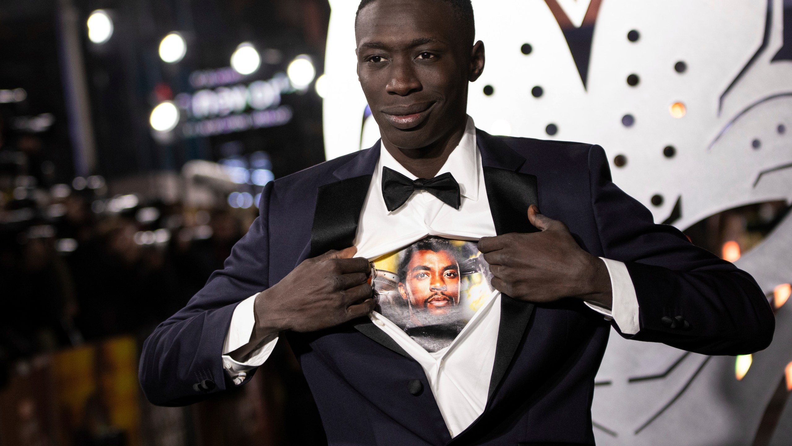 FILE - Khaby Lame opens his shirt to reveal the image of Chadwick Boseman upon arrival for the premiere of the film 'Black Panther: Wakanda Forever' in London, Nov. 3, 2022. (Photo by Vianney Le Caer/Invision/AP File)