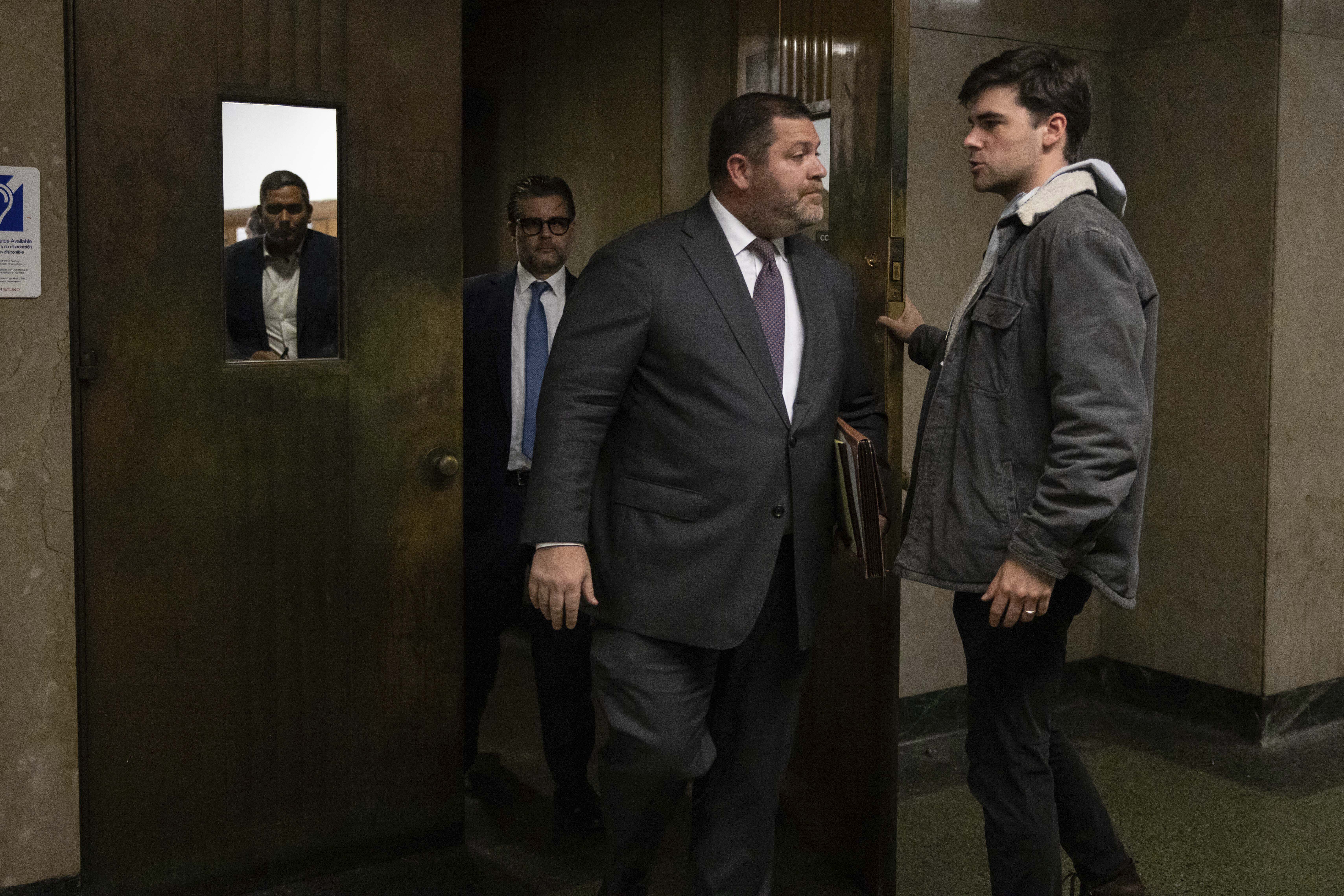 Wayne Gosnell, center, attorney for John Woeltz, cryptocurrency investor charged for kidnapping and false imprisonment, exits a courtroom, Wednesday, May 28, 2025, in New York. (AP Photo/Yuki Iwamura)