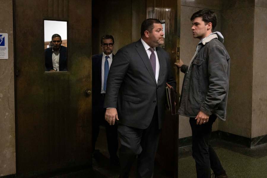 Wayne Gosnell, center, attorney for John Woeltz, cryptocurrency investor charged for kidnapping and false imprisonment, exits a courtroom, Wednesday, May 28, 2025, in New York. (AP Photo/Yuki Iwamura)