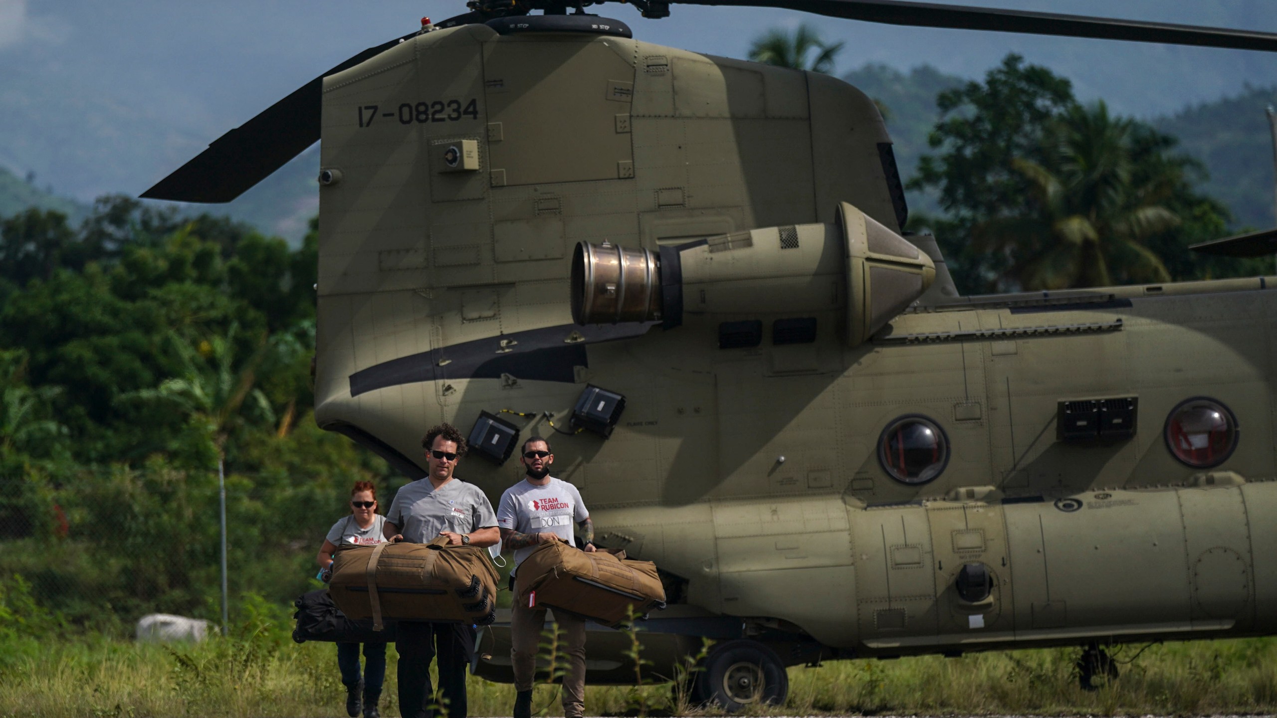 FILE - Team Rubicon's disaster response members unload aid at the airport following a 7.2 magnitude earthquake, in Les Cayes, Haiti, Aug. 19, 2021. (AP Photo/Fernando Llano, File)