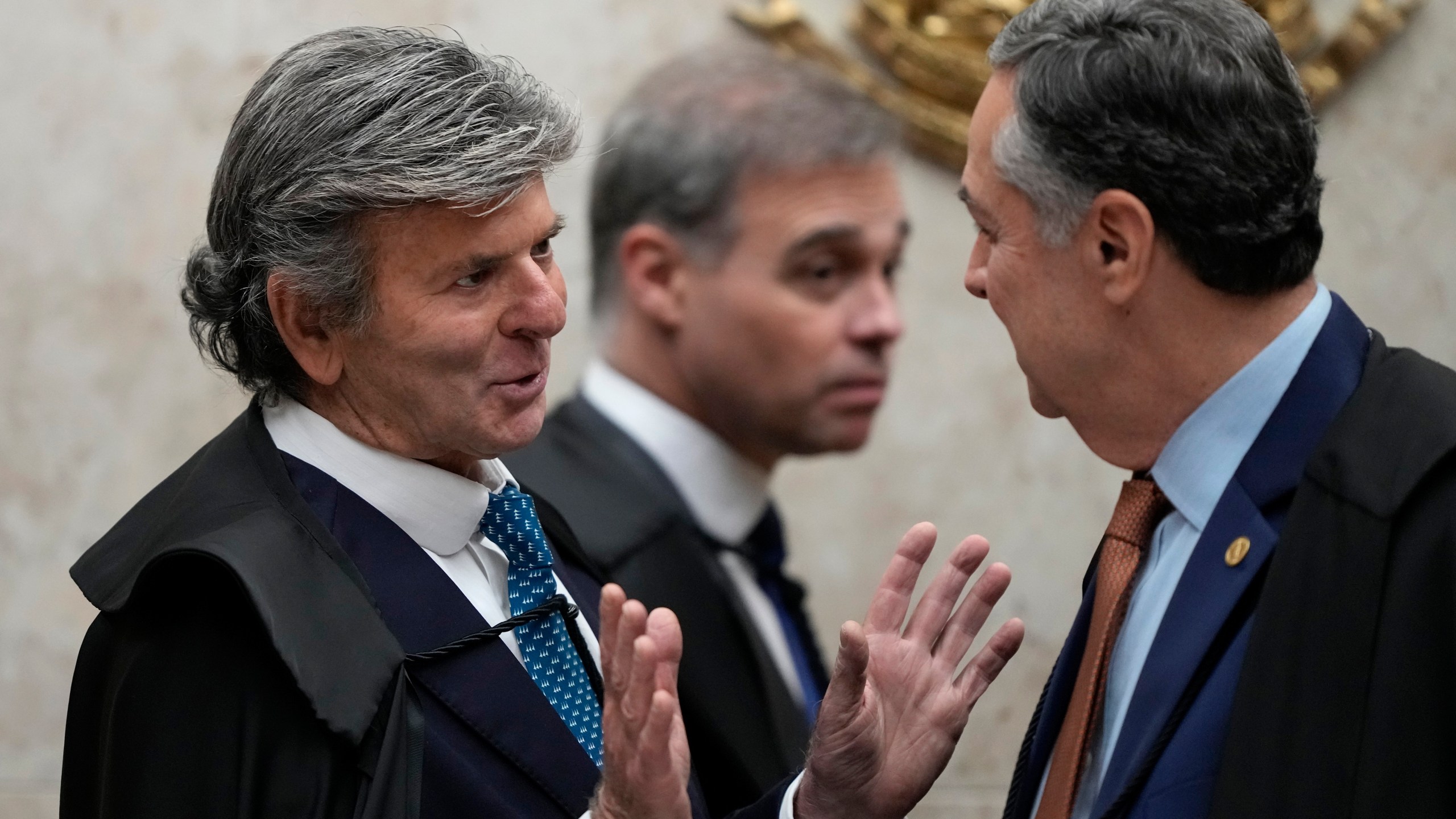 Minister Luiz Fux, left, Google Brazil’s rapporteur, talks with Supreme Court Chief Justice Roberto Barroso, during the court’s resumption of social media regulation cases regarding online disinformation, in Brasilia, Brazil, Wednesday, June 4, 2025. (AP Photo/Eraldo Peres)