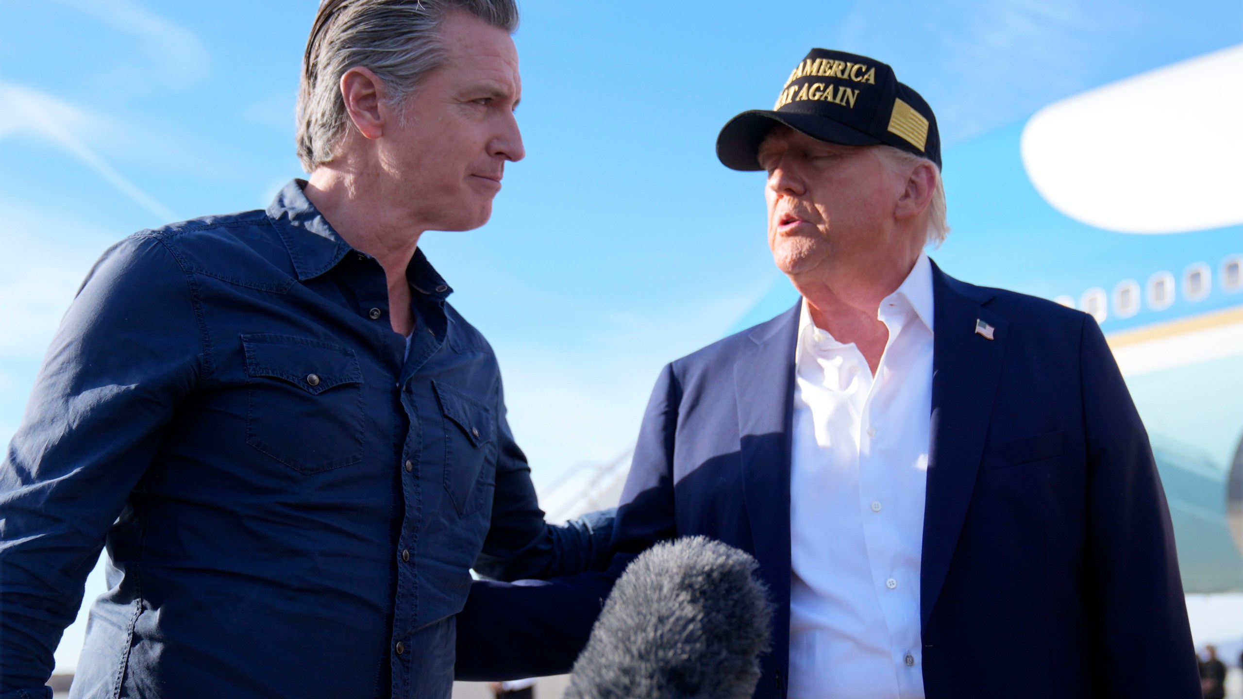 FILE - President Donald Trump talks with California Gov. Gavin Newsom after arriving on Air Force One at Los Angeles International Airport in Los Angeles, Jan. 24, 2025. (AP Photo/Mark Schiefelbein, File)