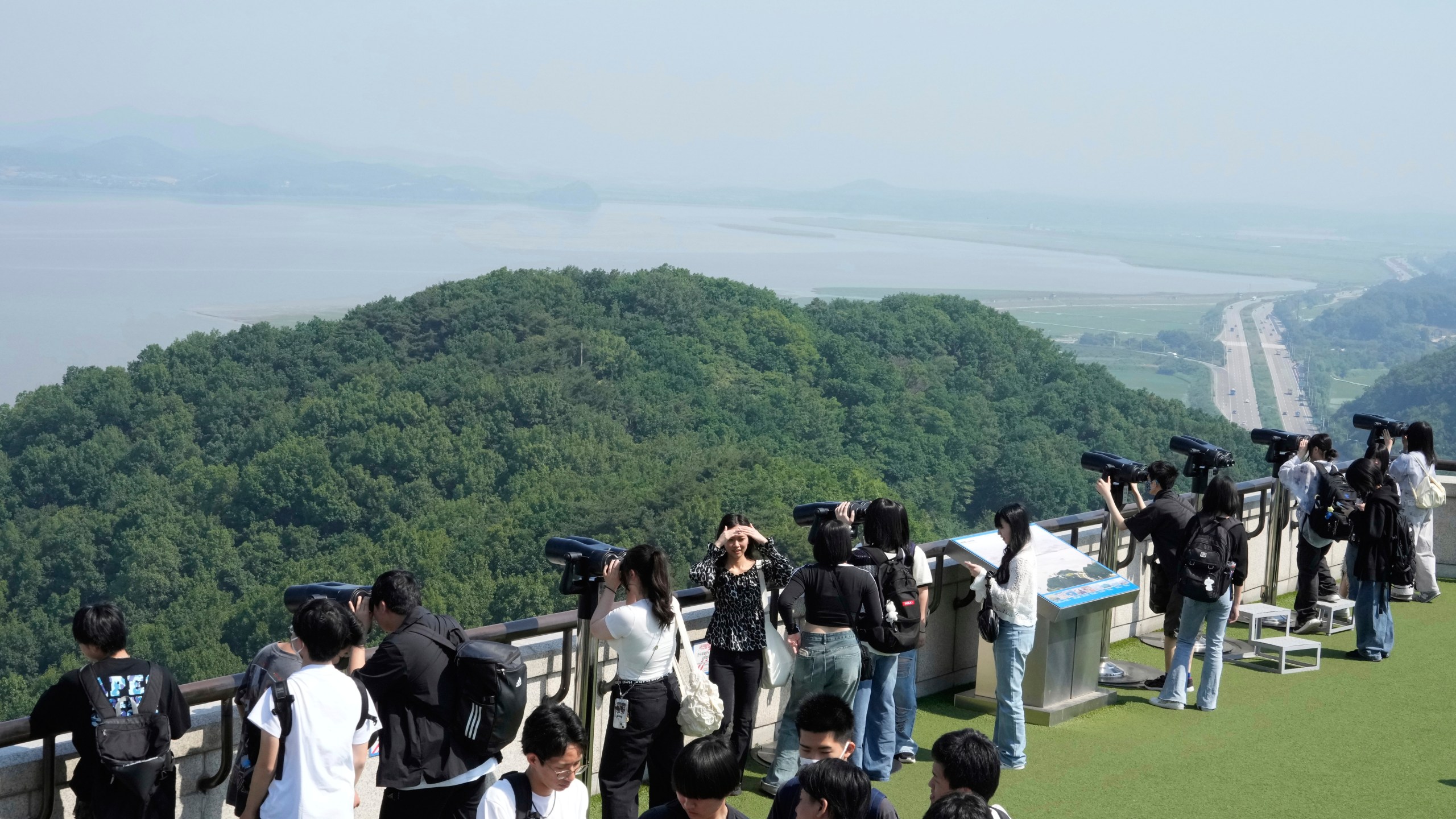 Visitors watch the North Korea side from the unification observatory in Paju, South Korea, near the border with North Korea, Thursday, June 12, 2025. (AP Photo/Ahn Young-joon)