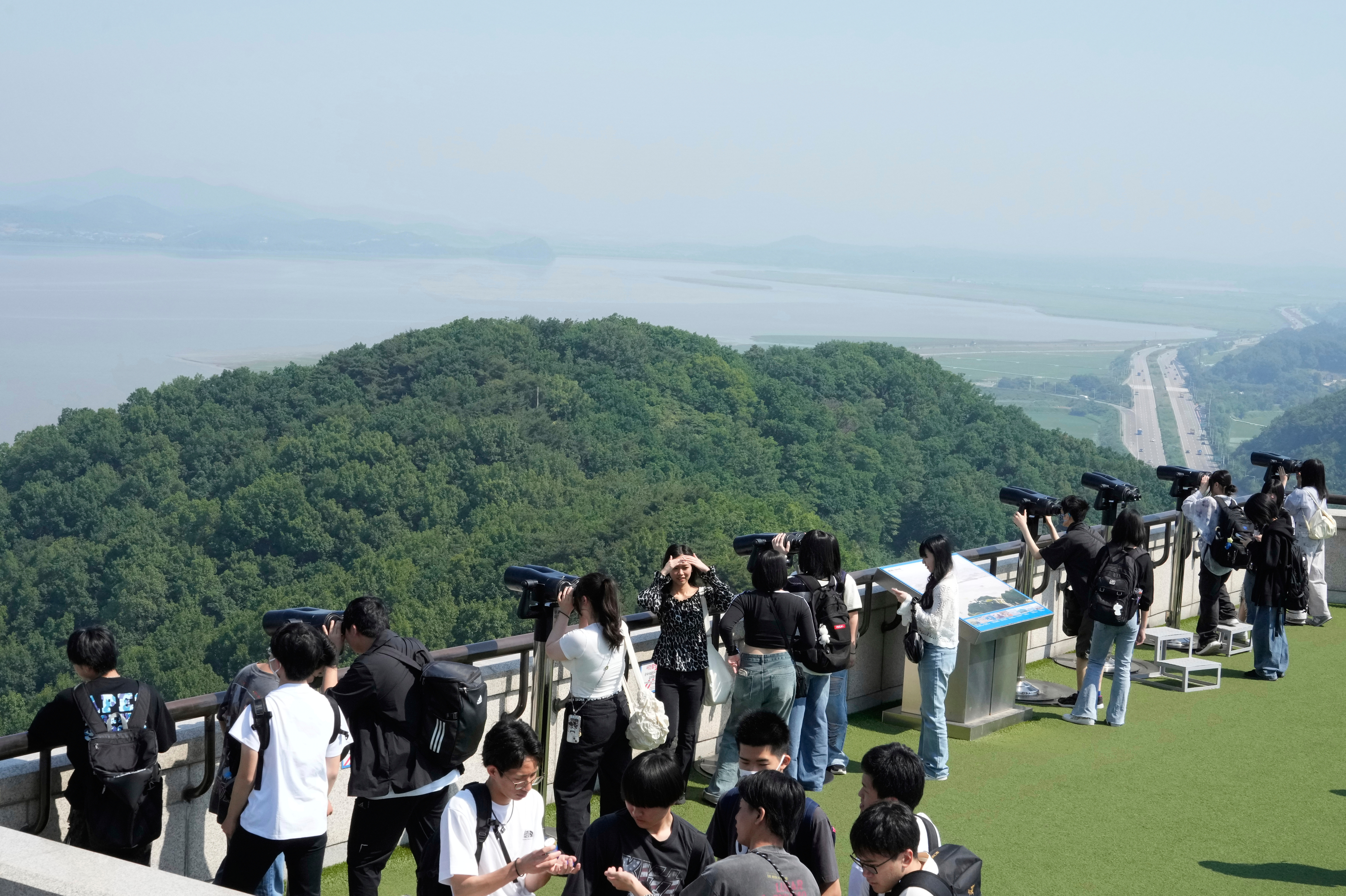 Visitors watch the North Korea side from the unification observatory in Paju, South Korea, near the border with North Korea, Thursday, June 12, 2025. (AP Photo/Ahn Young-joon)