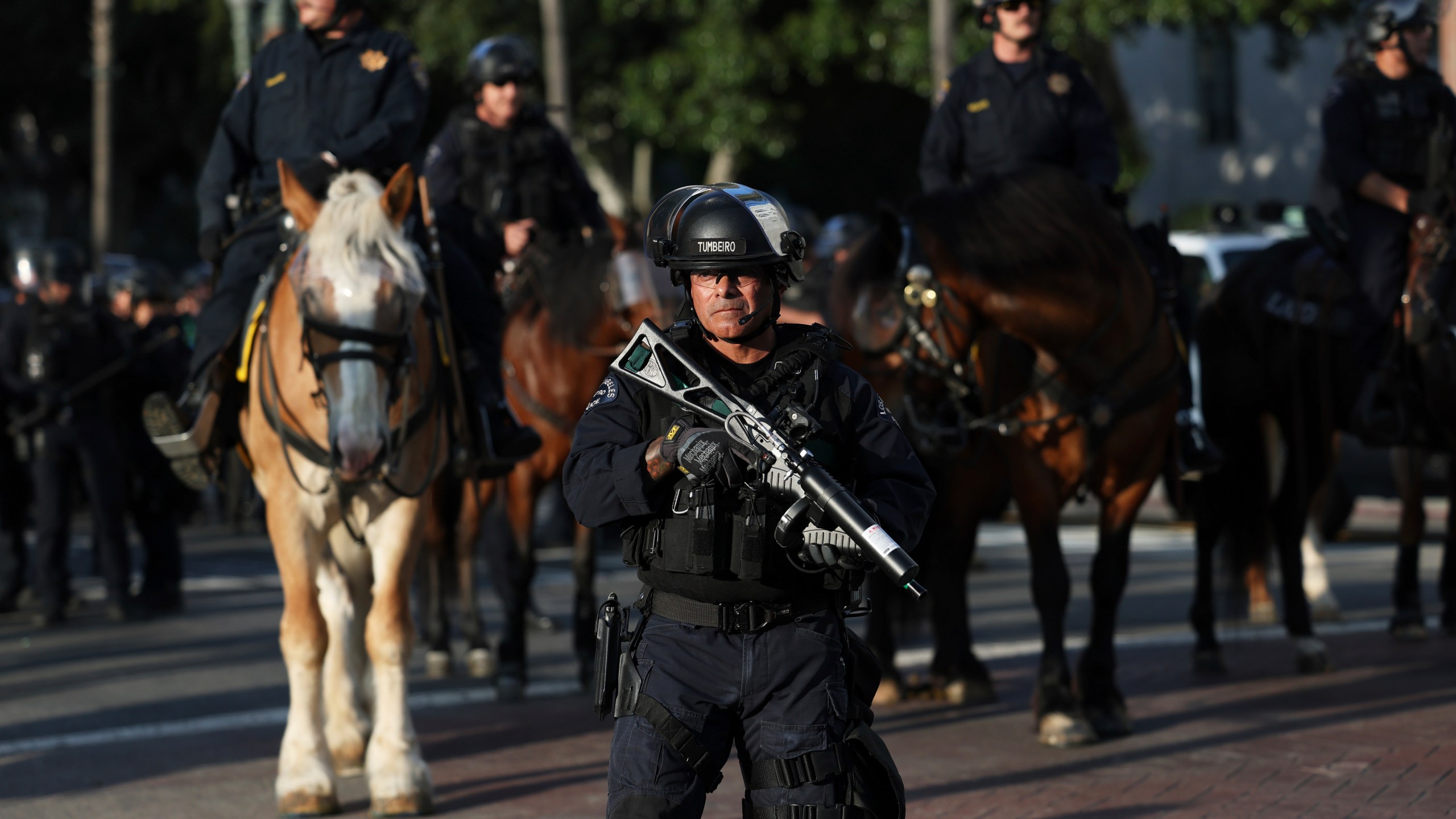 A Los Angeles Metro police officer stands guard during a protest on Wednesday, June 11, 2025, in Los Angeles. (AP Photo/Ethan Swope)