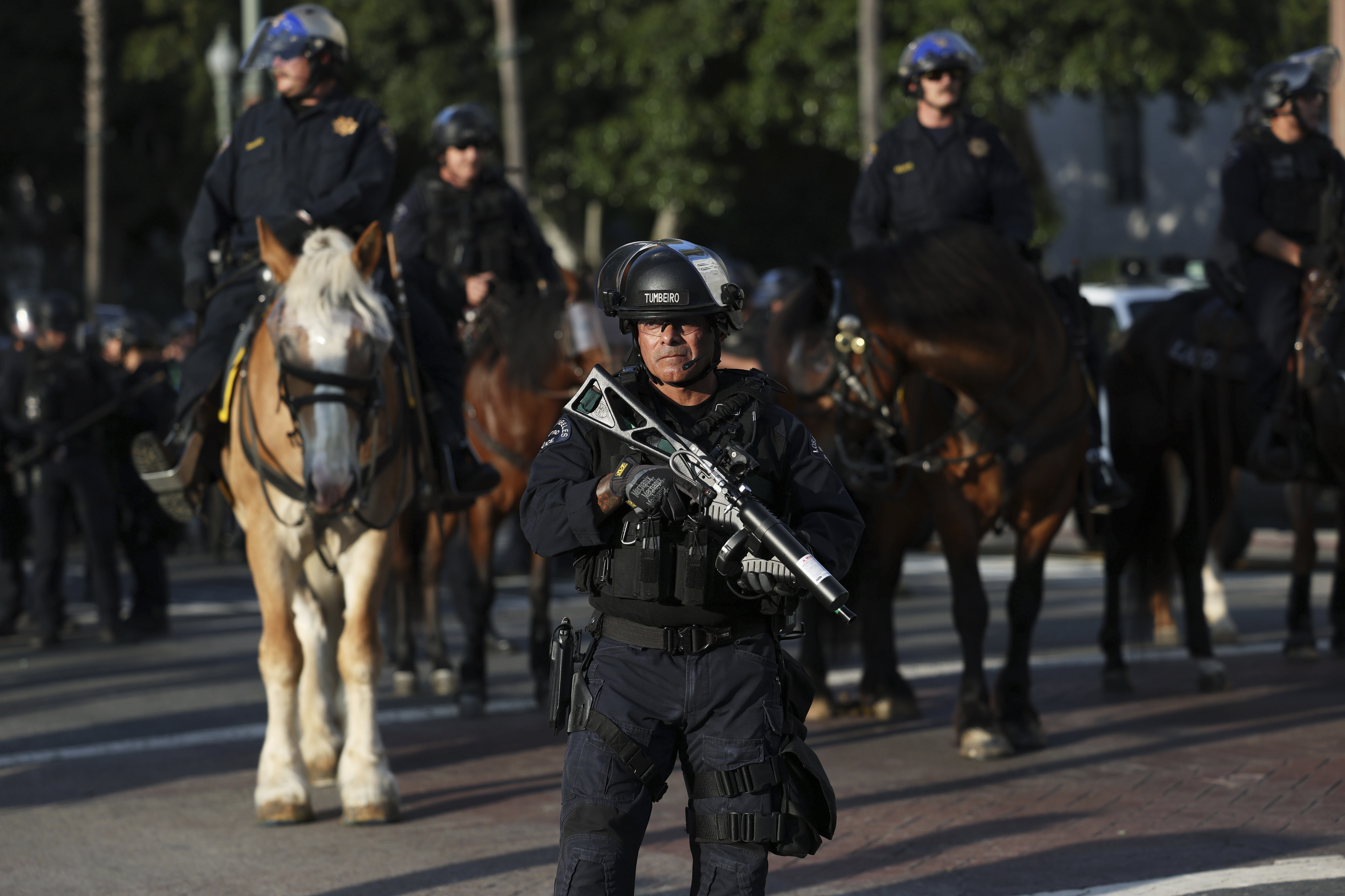 A Los Angeles Metro police officer stands guard during a protest on Wednesday, June 11, 2025, in Los Angeles. (AP Photo/Ethan Swope)