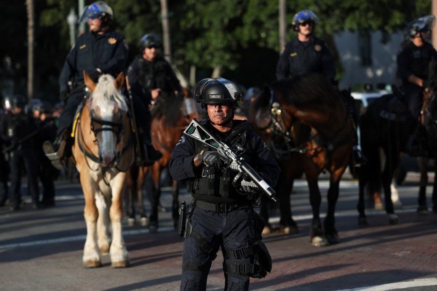 A Los Angeles Metro police officer stands guard during a protest on Wednesday, June 11, 2025, in Los Angeles. (AP Photo/Ethan Swope)