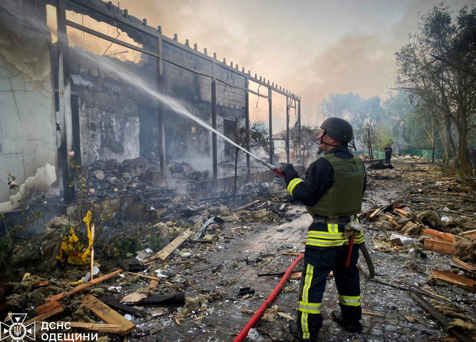 In this photo provided by the Ukrainian Emergency Service, a firefighter tackles a blaze after a Russian attack that hit a private house in Odesa region, Ukraine, Wednesday, June 11, 2025. (Ukrainian Emergency Service via AP)