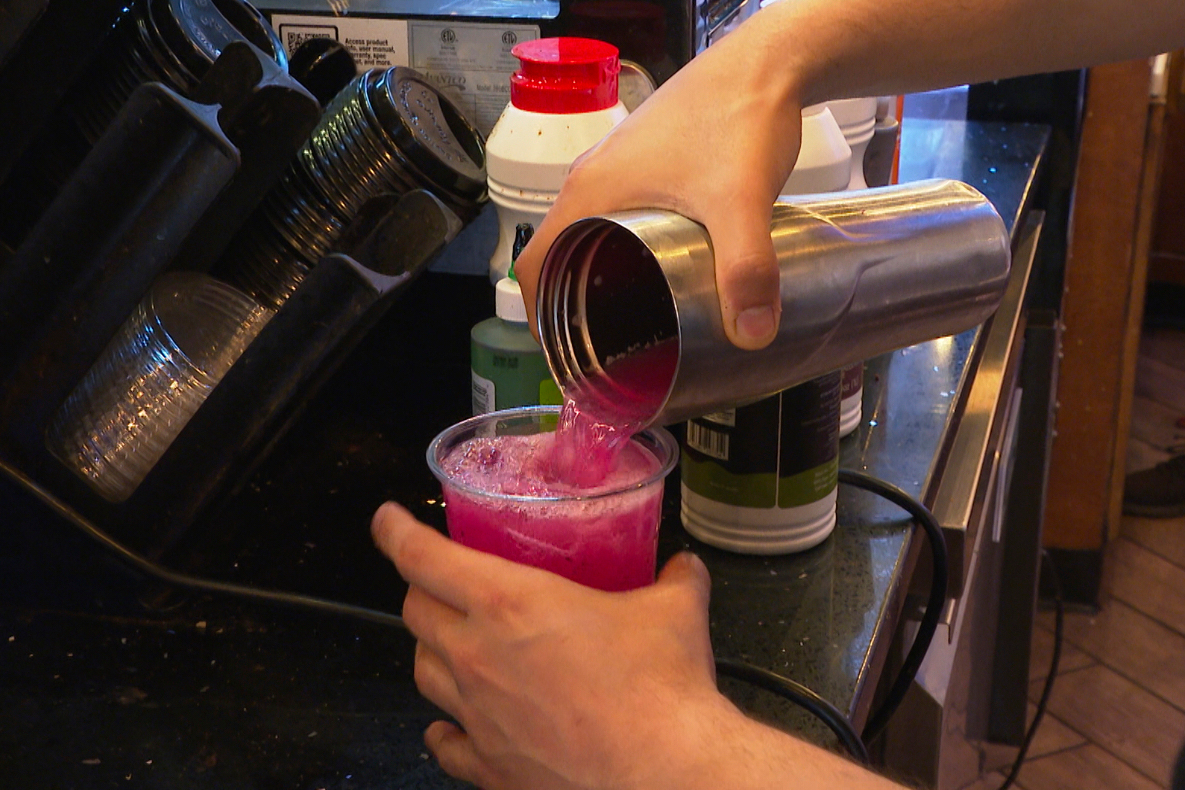 In this image made from video, a Haraz Coffee House employee makes a drink Monday, June 9, 2025, in Dearborn, Mich. (AP Photo/Mike Householder)