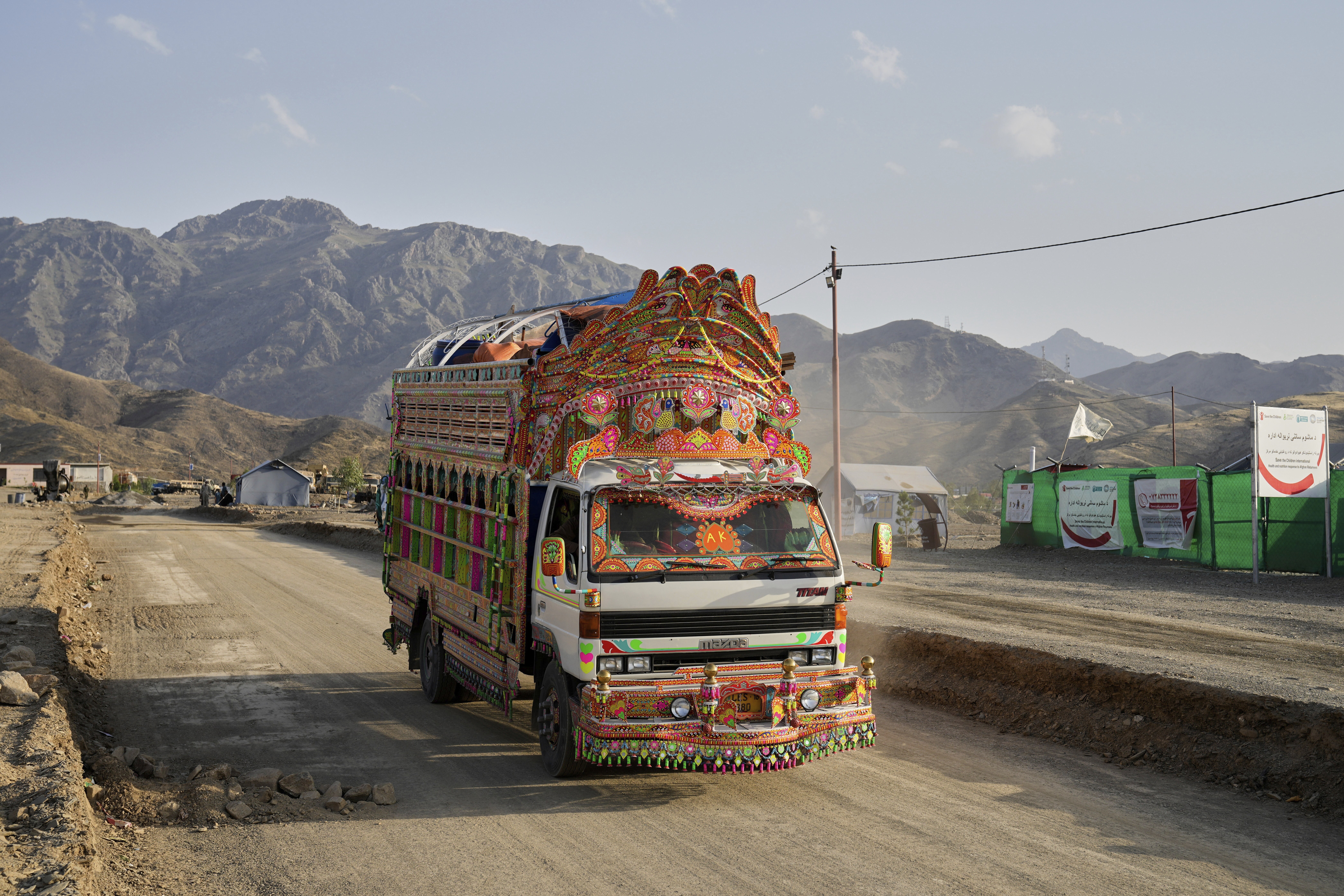 A Pakistani truck carrying repatriated Afghan refugees arrives at a camp near the Pakistan-Afghanistan border, in Torkham, Afghanistan, Saturday, May 31, 2025. (AP Photo/Ebrahim Noroozi)
