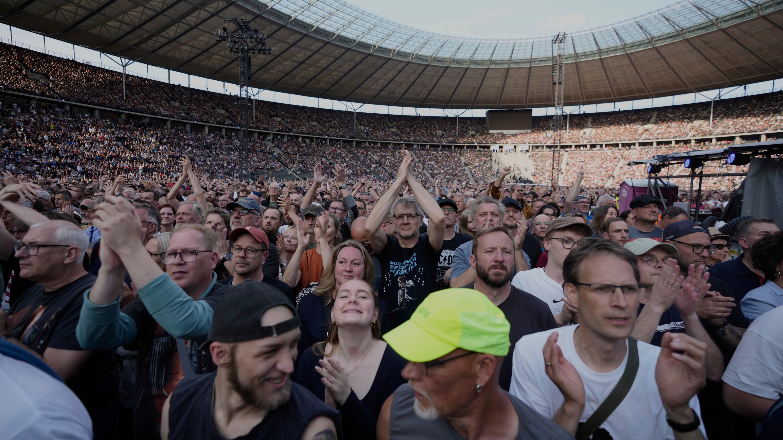Spectators watch Bruce Springsteen and the E Street Band perform at the Olympic Stadium, in Berlin, Germany, Wednesday, June 11, 2025. (AP Photo/Markus Schreiber)