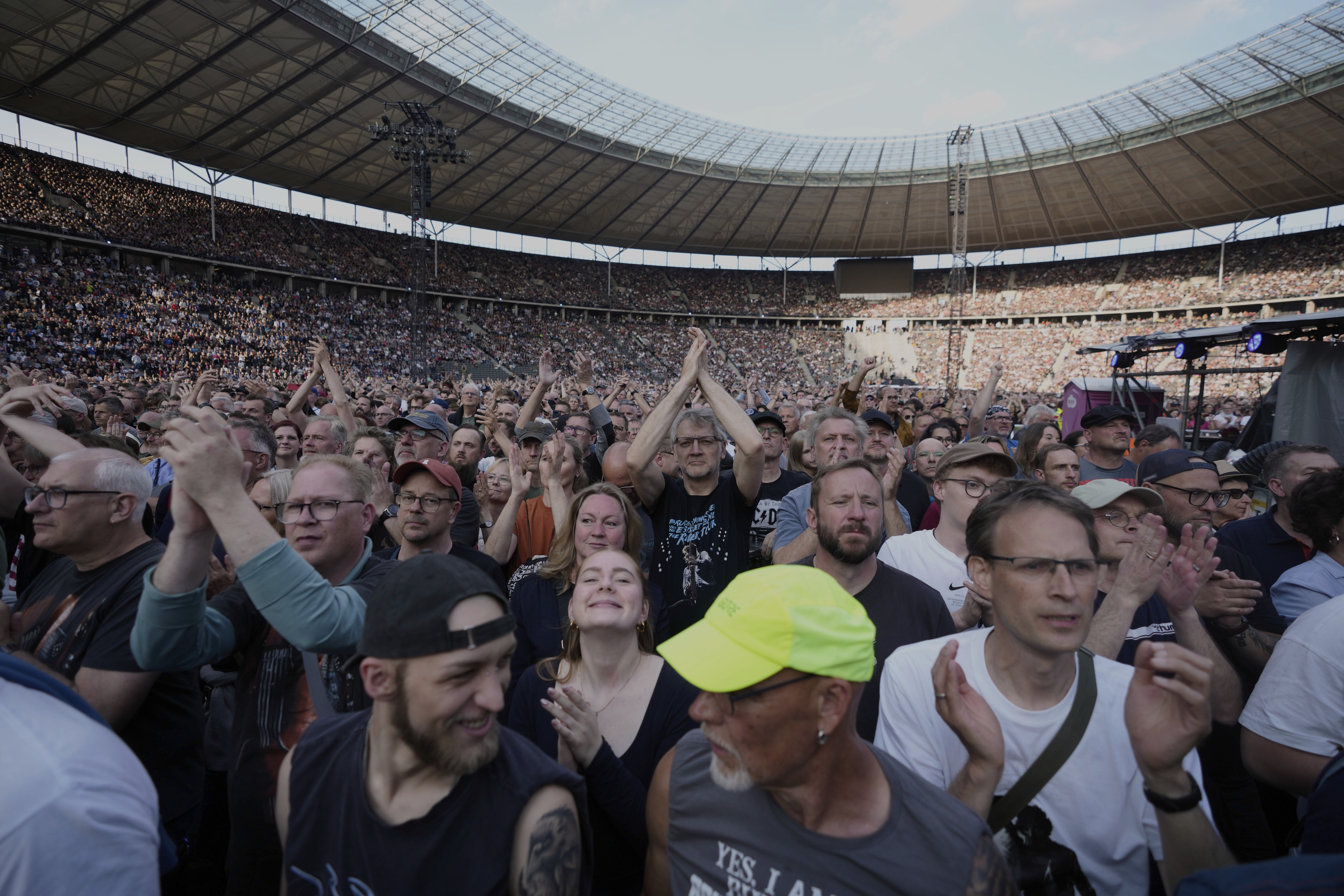 Spectators watch Bruce Springsteen and the E Street Band perform at the Olympic Stadium, in Berlin, Germany, Wednesday, June 11, 2025. (AP Photo/Markus Schreiber)