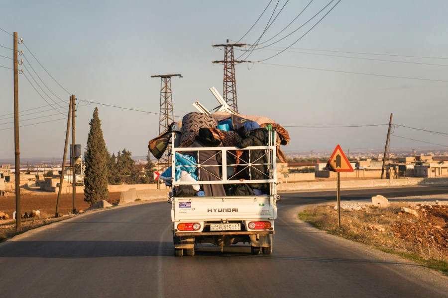 FILE - Syrian refugee Ahmed al-Kassem and his family drive a truck loaded with their belongings from Turkey, on the their way back to the family's home in Aleppo, Syria, Friday, Dec. 13, 2024. (AP Photo/Khalil Hamra, File)