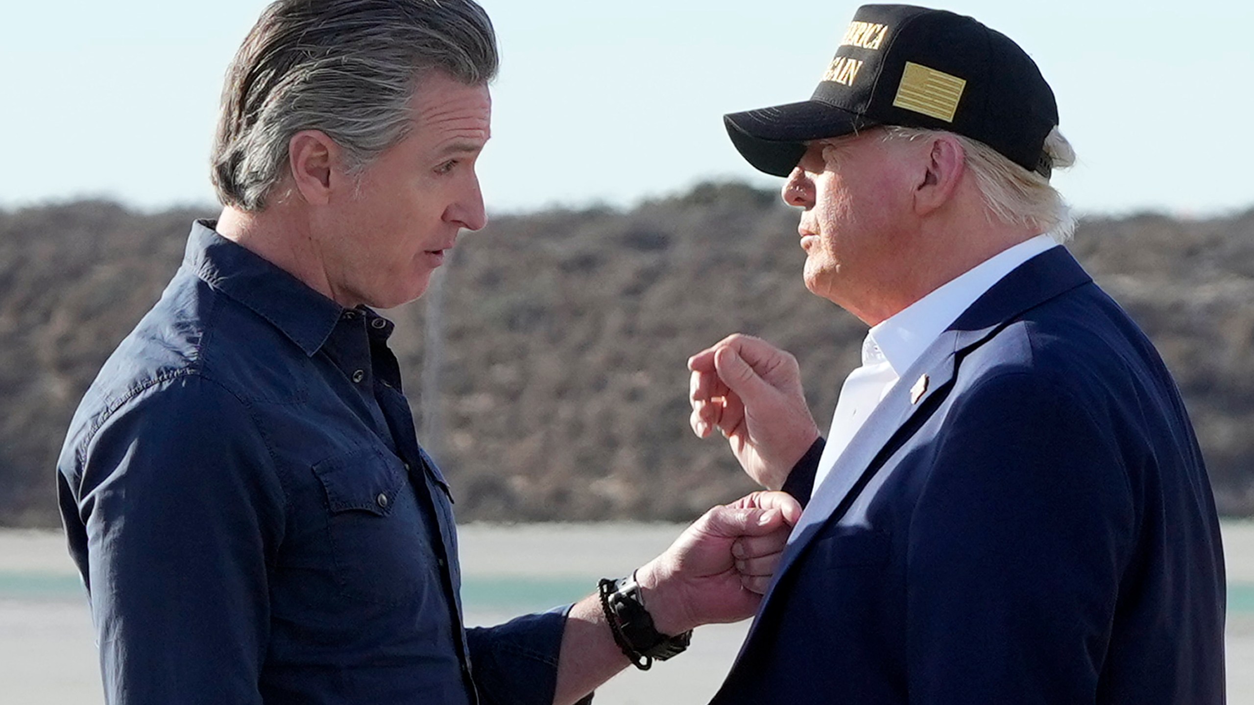 FILE - President Donald Trump talks with California Gov. Gavin Newsom after arriving on Air Force One at Los Angeles International Airport in Los Angeles, Jan. 24, 2025. (AP Photo/Mark Schiefelbein, File)