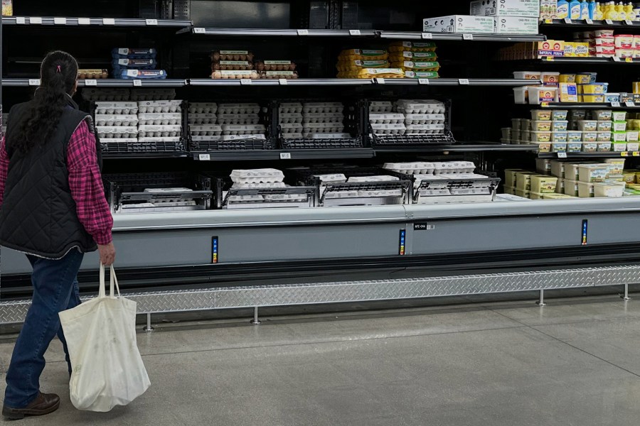 FILE - A shopper passes by the display of cartons of eggs in a Walmart store Friday, Feb. 7, 2025, in Englewood, Colo. (AP Photo/David Zalubowski, File)
