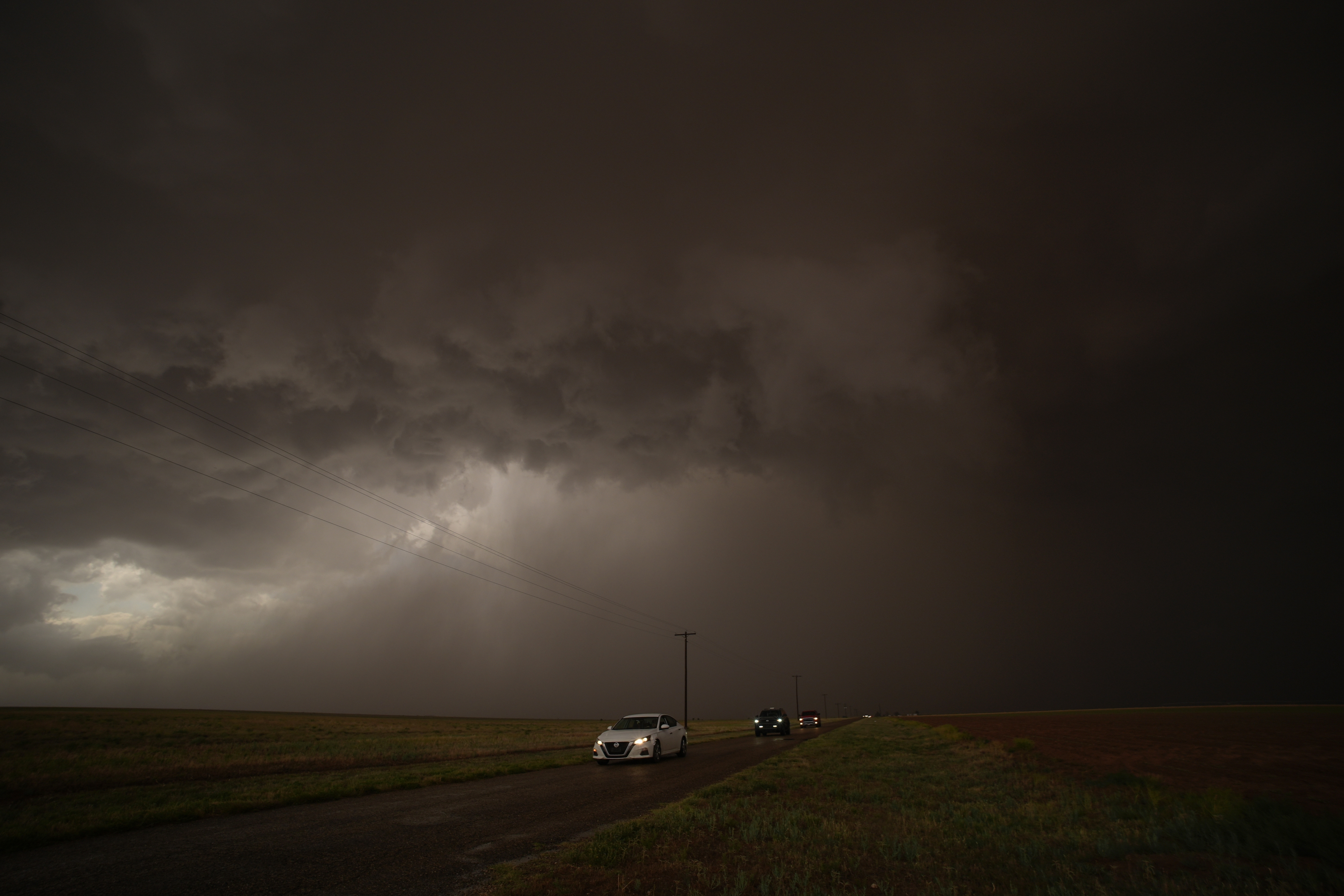 Cars dive away from a storm during a Project ICECHIP operation Thursday, June 5, 2025, in Morton, Texas. (AP Photo/Carolyn Kaster)