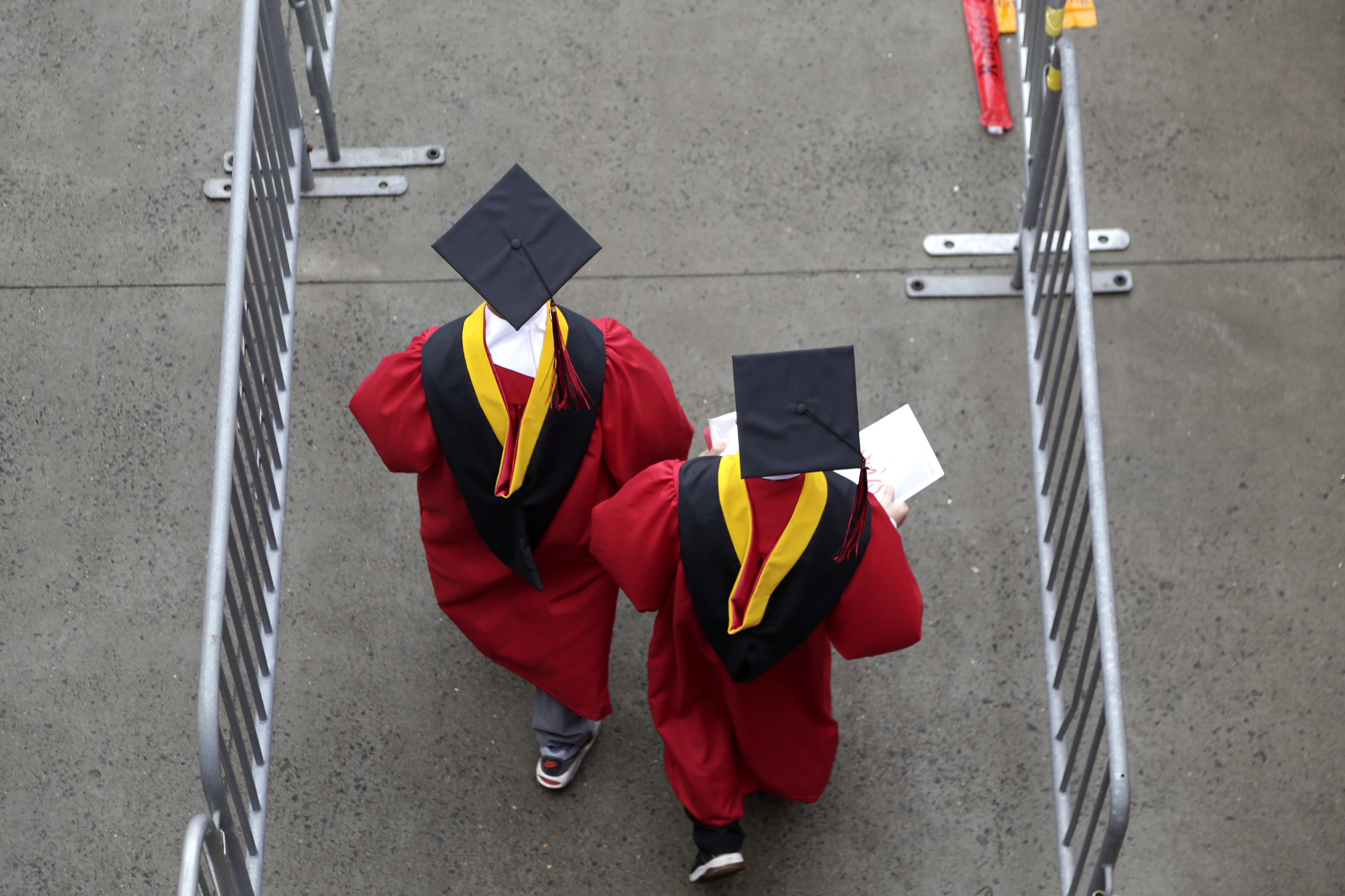 FILE - Graduates walk into the High Point Solutions Stadium before the start of the Rutgers University graduation ceremony in Piscataway Township, N.J., on May 13, 2018. (AP Photo/Seth Wenig, File)
