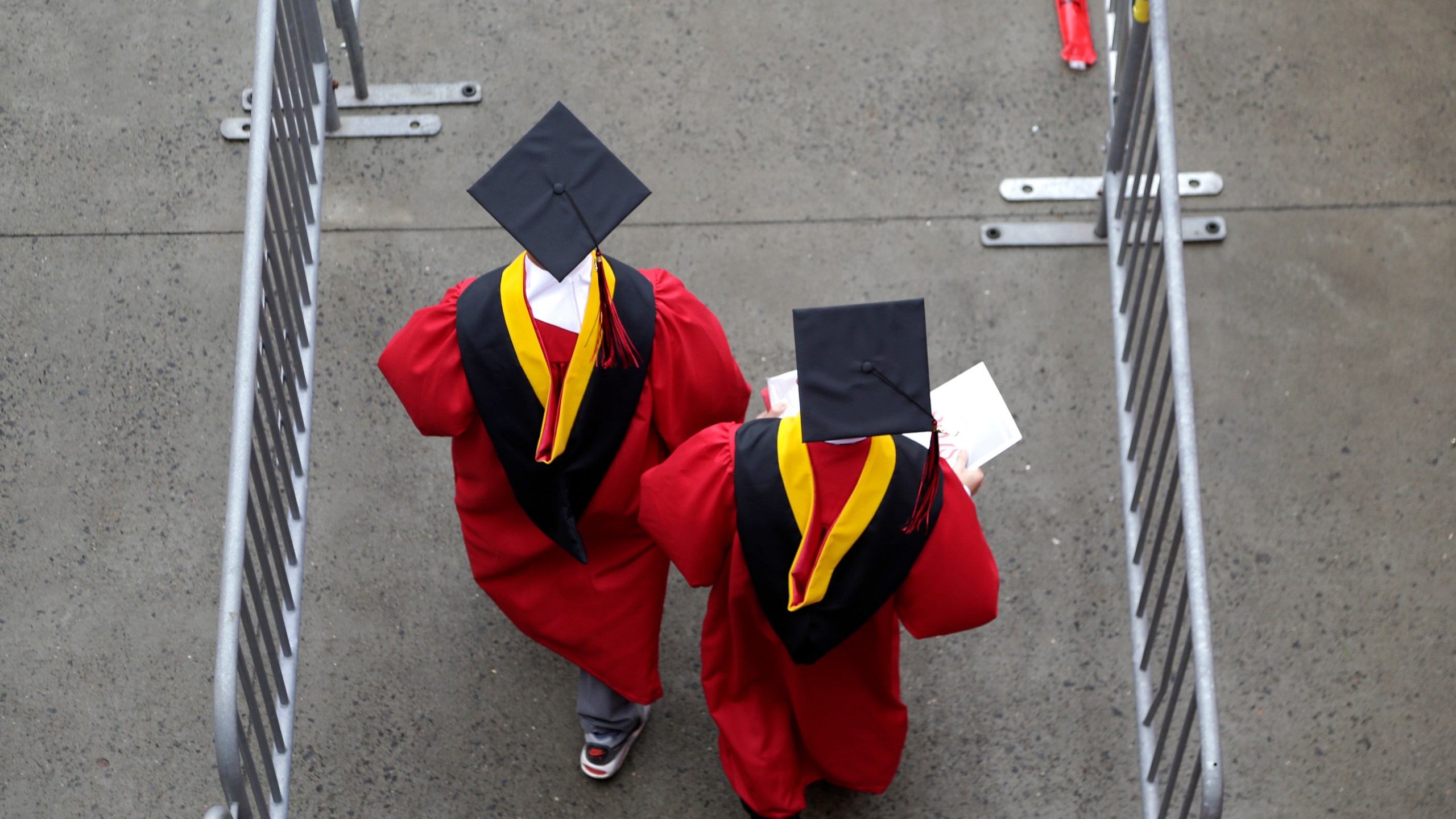 FILE - Graduates walk into the High Point Solutions Stadium before the start of the Rutgers University graduation ceremony in Piscataway Township, N.J., on May 13, 2018. (AP Photo/Seth Wenig, File)
