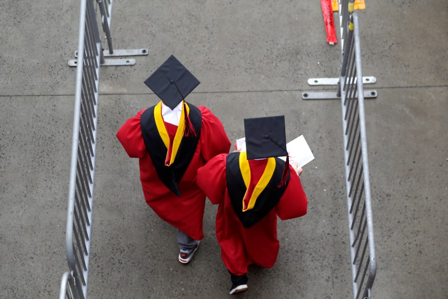 FILE - Graduates walk into the High Point Solutions Stadium before the start of the Rutgers University graduation ceremony in Piscataway Township, N.J., on May 13, 2018. (AP Photo/Seth Wenig, File)