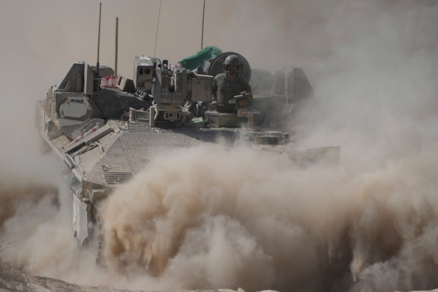 An Israeli army armored personnel carrier maneuvers near the Israel-Gaza border, southern Israel, Wednesday, June 11, 2025. (AP Photo/Ariel Schalit)