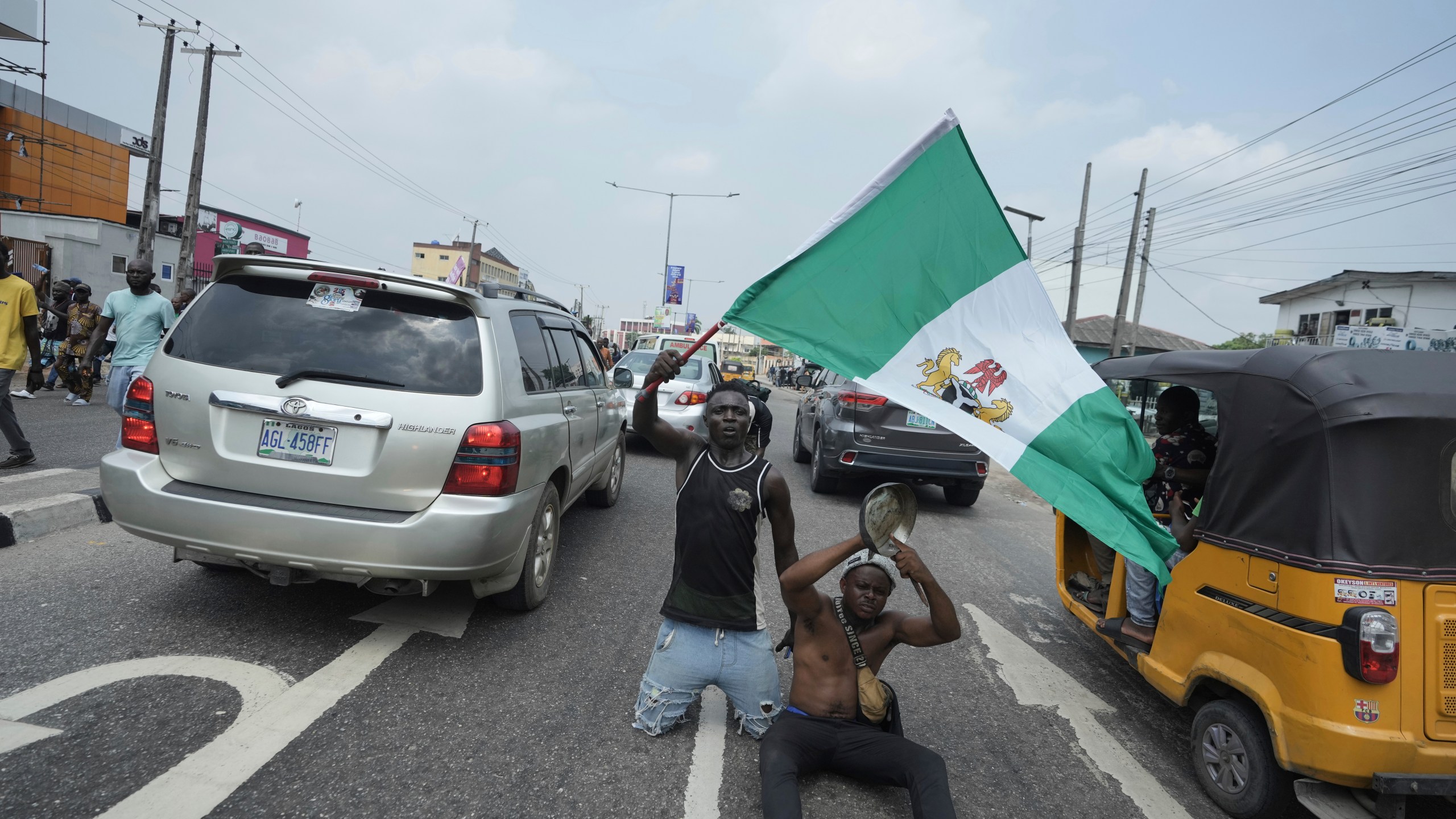 People attend anti-government protests on streets of Lagos, Nigeria, Thursday, June 12, 2025. (AP Photo/Sunday Alamba)