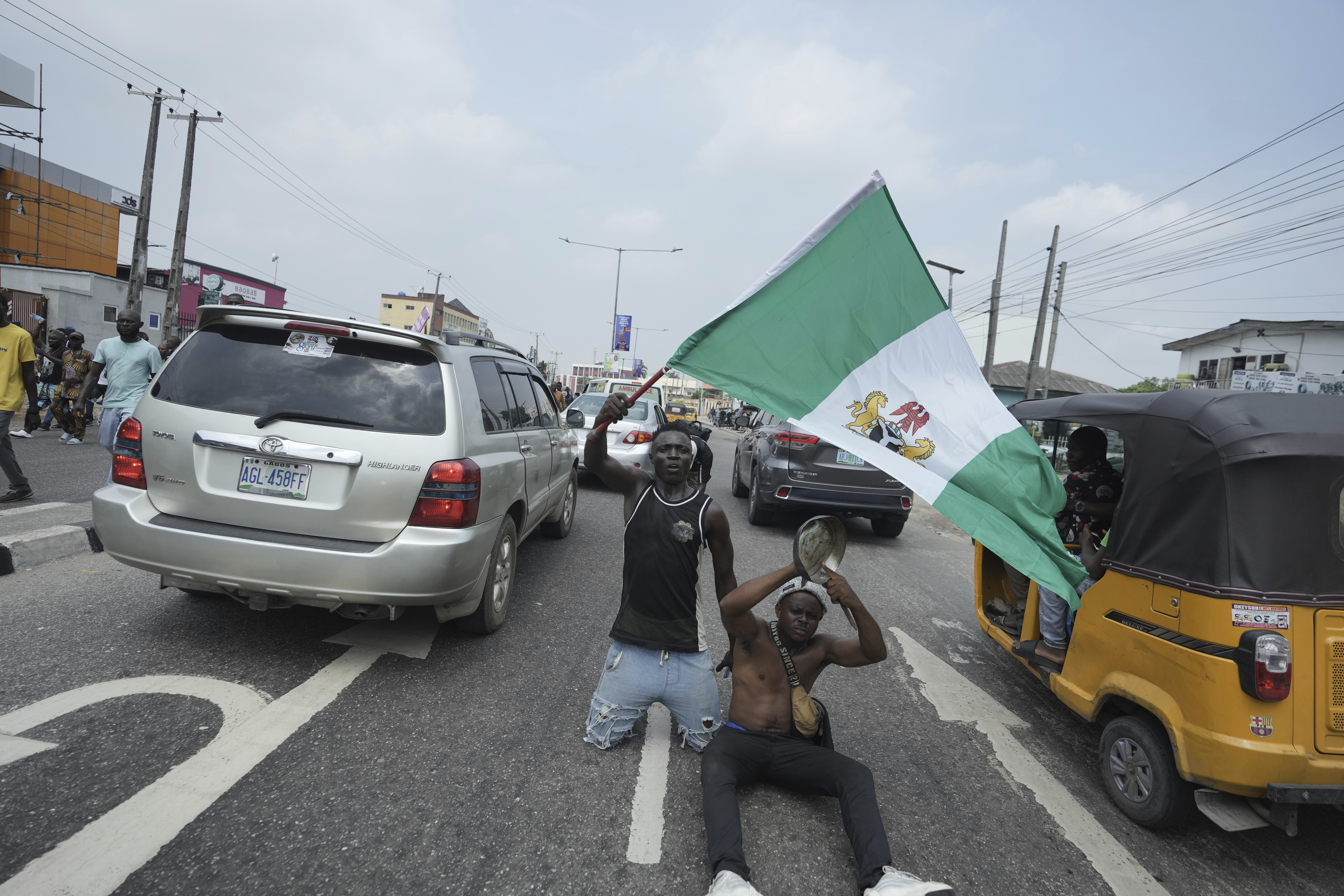 People attend anti-government protests on streets of Lagos, Nigeria, Thursday, June 12, 2025. (AP Photo/Sunday Alamba)
