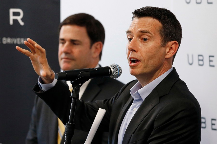 FILE - David Plouffe, right, Uber senior vice president of policy and communications, talks about the Uber expansion in Phoenix as Arizona Gov. Doug Ducey listens during a news conference announcing the opening of the new Uber offices June 11, 2015, in Phoenix. (AP Photo/Ross D. Franklin, File)