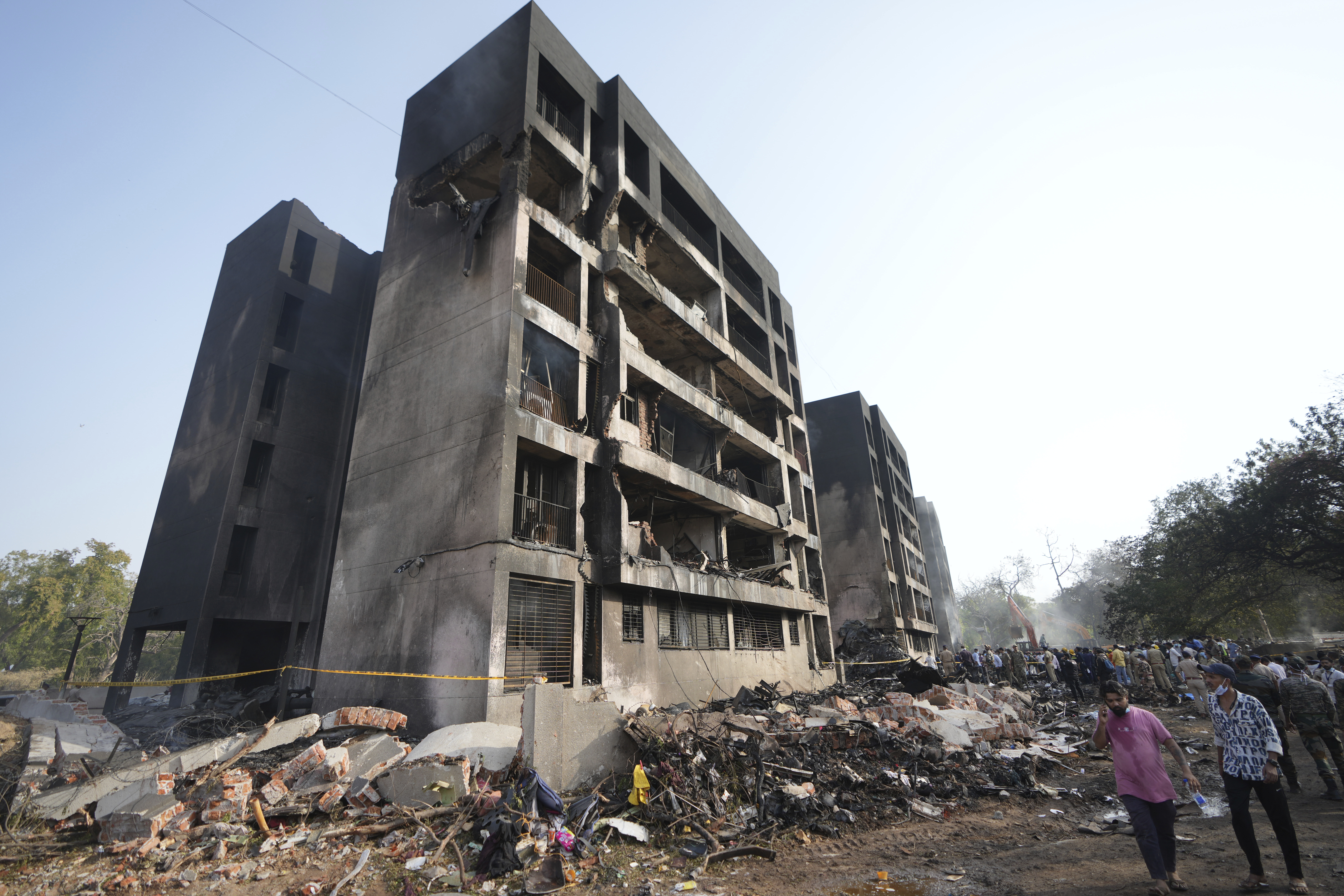 Search and rescue teams respond to the scene of a plane crash in Ahmedabad, India, Thursday, June 12, 2025. (AP Photo/Ajit Solanki)