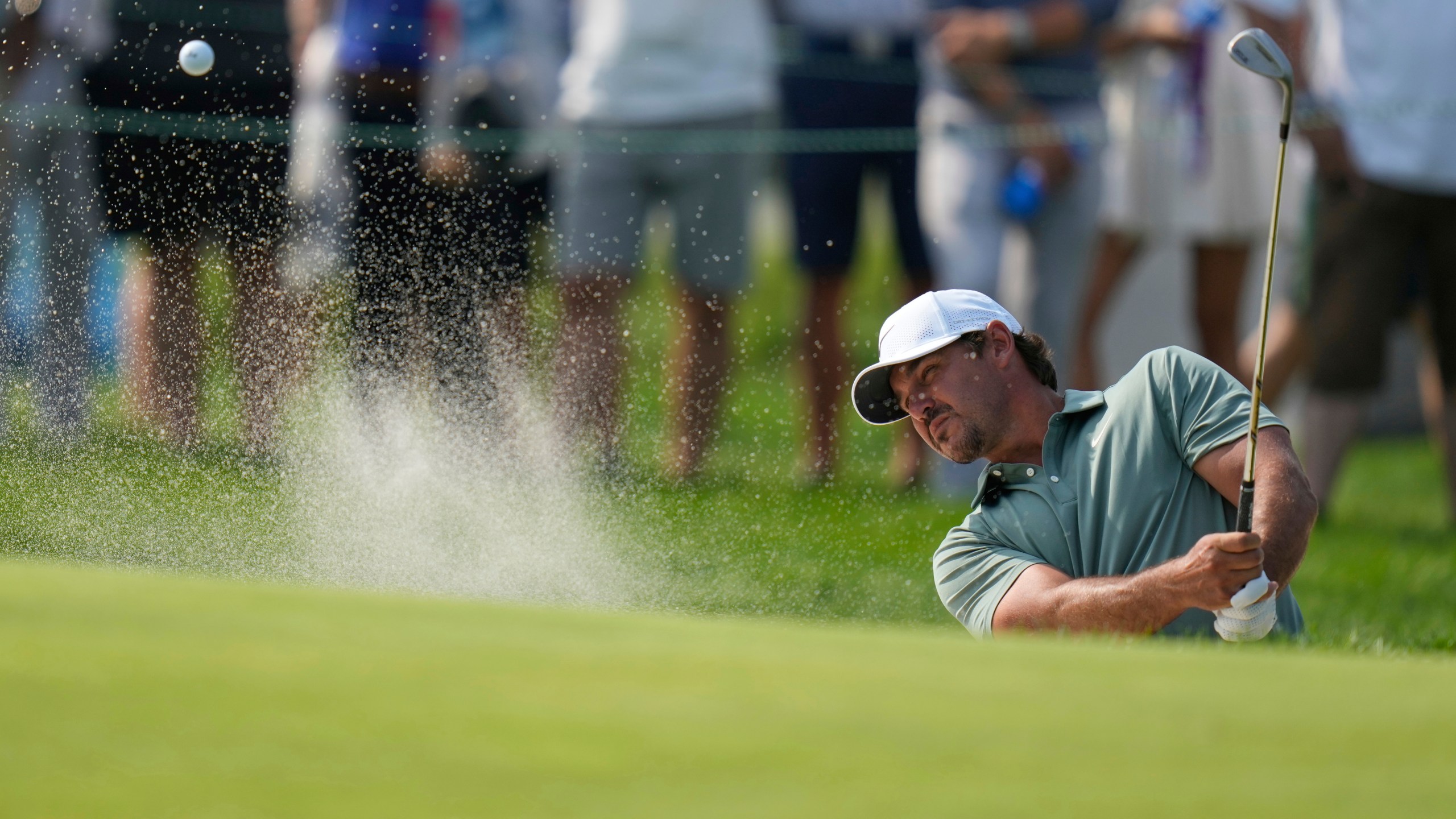 Brooks Koepka hits from a bunker on the 13th hole during the first round of the U.S. Open golf tournament at Oakmont Country Club Thursday, June 12, 2025, in Oakmont, Pa. (AP Photo/Seth Wenig)