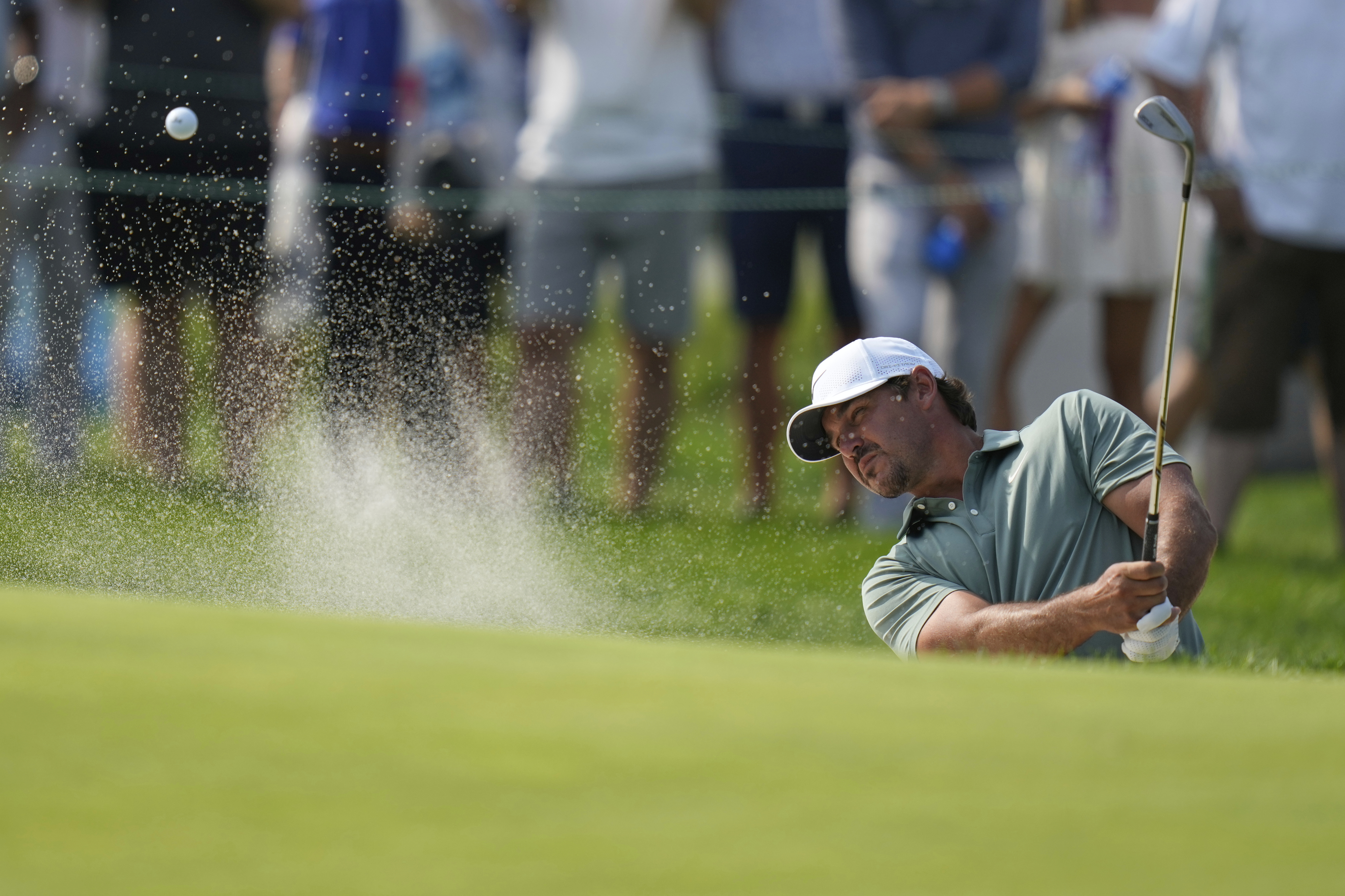 Brooks Koepka hits from a bunker on the 13th hole during the first round of the U.S. Open golf tournament at Oakmont Country Club Thursday, June 12, 2025, in Oakmont, Pa. (AP Photo/Seth Wenig)
