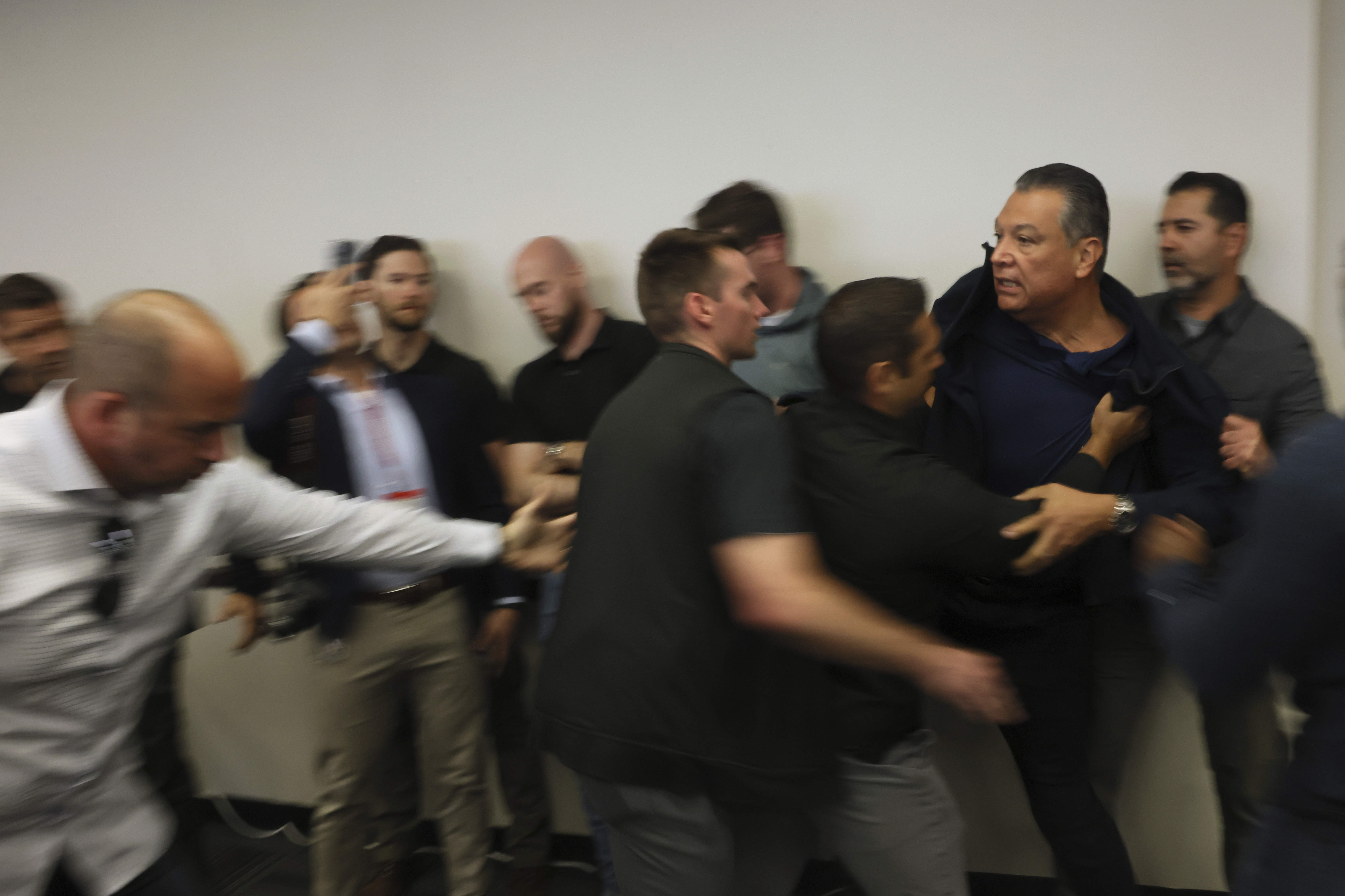 U.S. Sen. Alex Padilla, D-Calif., is pushed out of the room as Homeland Security Secretary Kristi Noem holds a news conference regarding the recent protests in Los Angeles on Thursday, June 12, 2025. (AP Photo/Etienne Laurent)