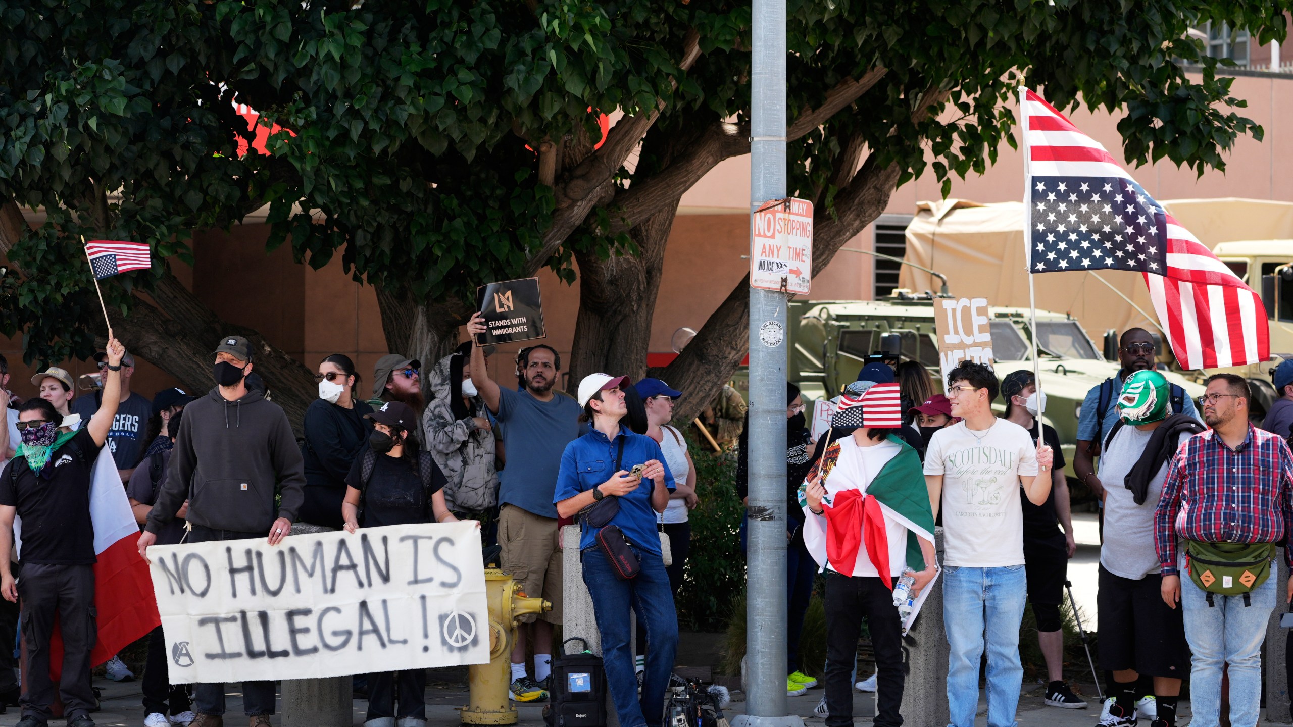 Protesters against federal immigration raids gather outside the Metropolitan Detention Center, Wednesday, June 11, 2025, in Los Angeles. (AP Photo/Damian Dovarganes)