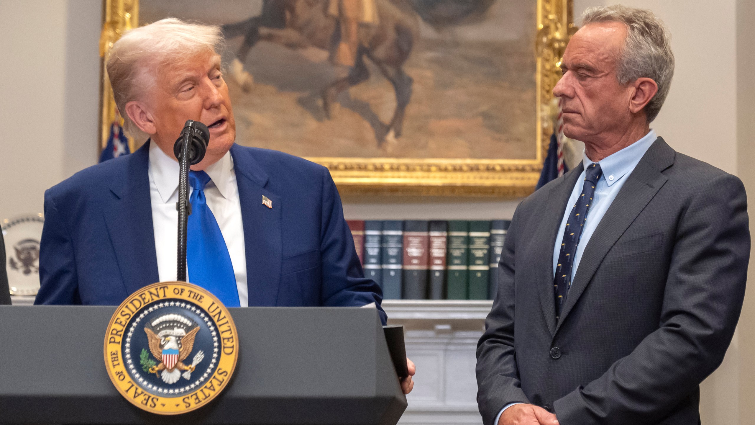 FILE - President Donald Trump, from left, speaks as Health and Human Services Secretary Robert F. Kennedy Jr., during an event in the Roosevelt Room at the White House, May 12, 2025, in Washington. (AP Photo/Mark Schiefelbein, File)\
