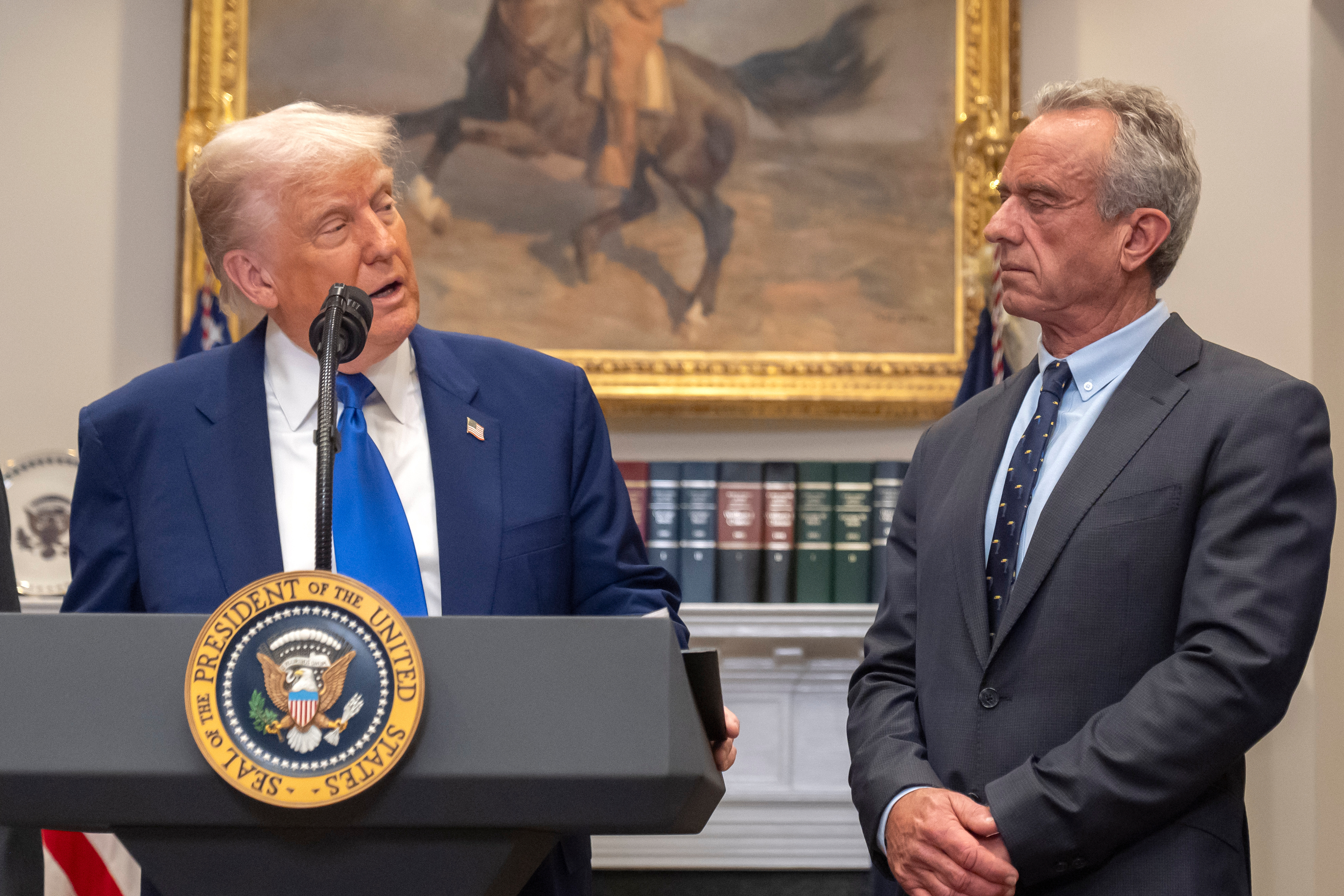 FILE - President Donald Trump, from left, speaks as Health and Human Services Secretary Robert F. Kennedy Jr., during an event in the Roosevelt Room at the White House, May 12, 2025, in Washington. (AP Photo/Mark Schiefelbein, File)\