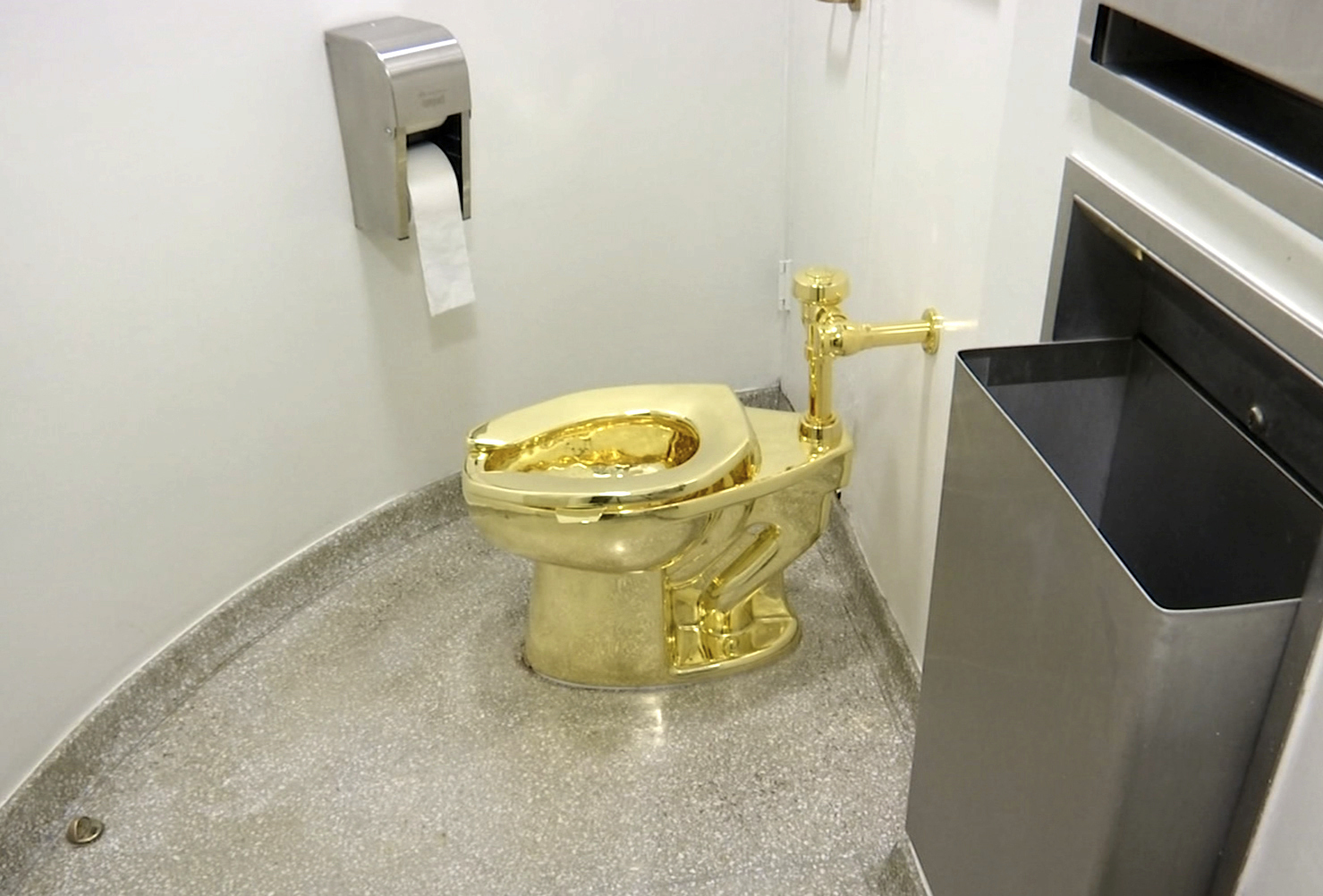 FILE - This Sept. 16, 2016 file image made from a video shows the 18-karat toilet, titled "America," by Maurizio Cattelan in the restroom of the Solomon R. Guggenheim Museum in New York. (AP Photo, File)