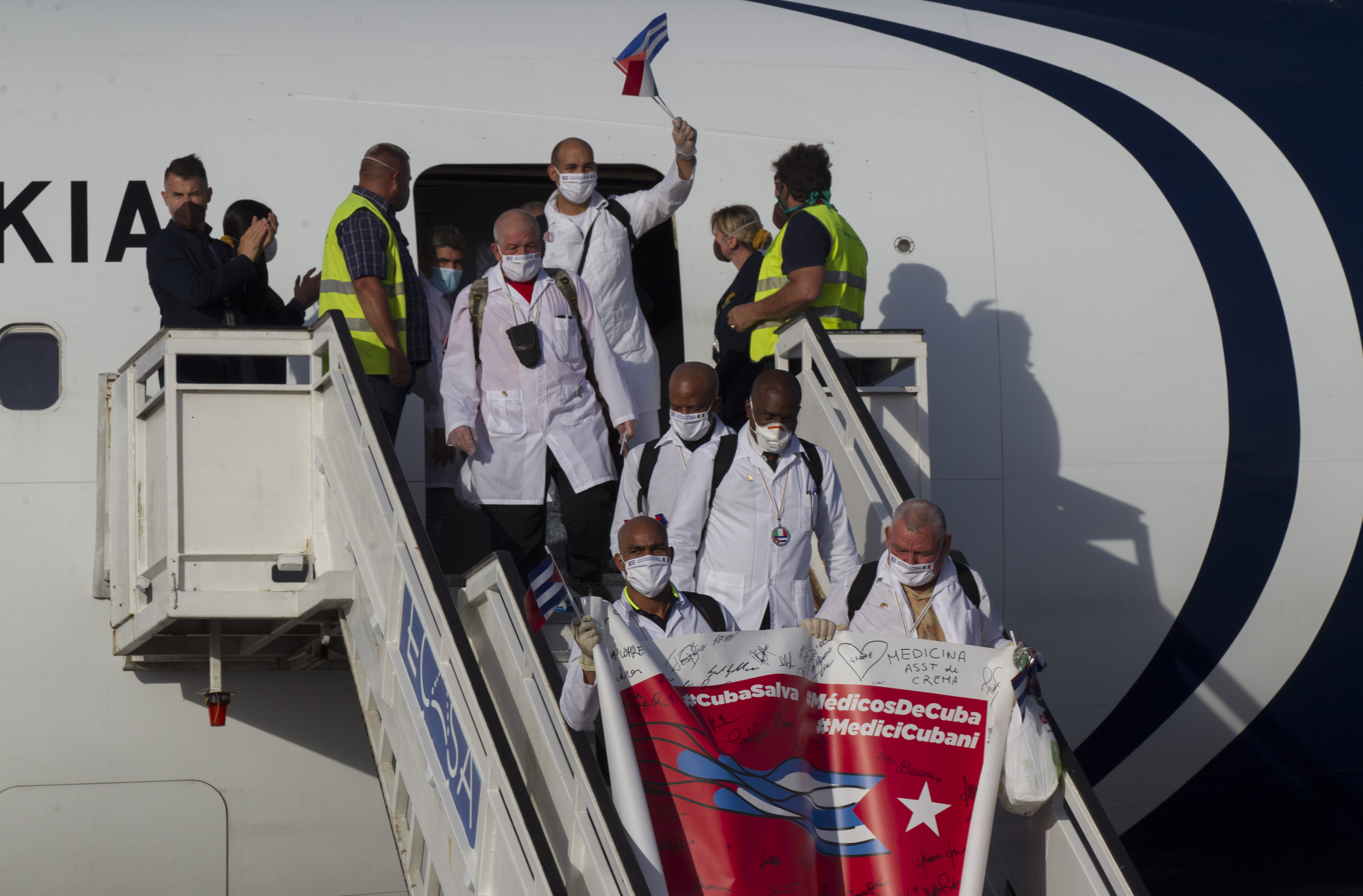 FILE - Cuban doctors arrive at the Jose Marti International Airport in Havana, Cuba, June 8, 2020, after traveling to Italy to help with the COVID-19 emergency response. (Ismael Francisco/Pool via AP, File)