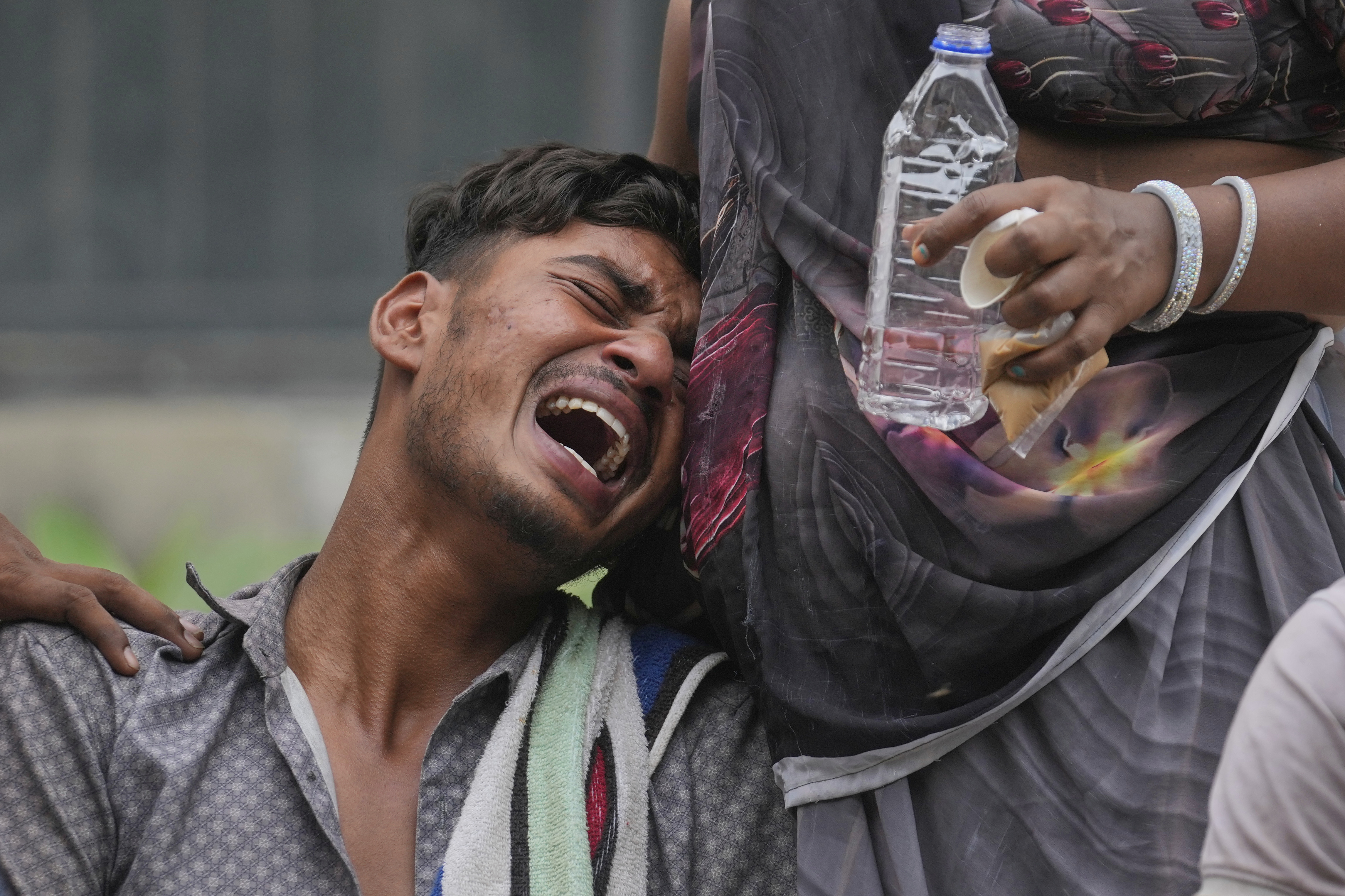 Kalpeshbhai Patni, whose 14-year-old brother was killed when an Air India plane crashed into a neighborhood, wails outside the autopsy room at a hospital in Ahmedabad, India, Friday, June 13, 2025. (AP Photo/Rafiq Maqbool)