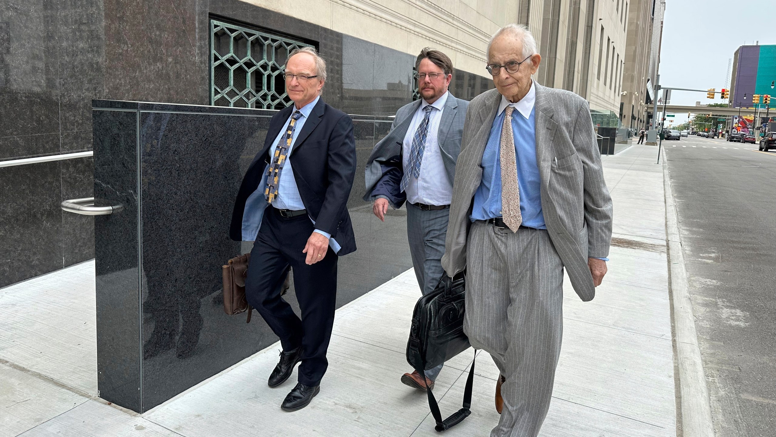 Defense lawyers for Chinese scientist Yunqing Jian, from left, David Duncan, James Gerometta and Norman Zalkind leave federal court in Detroit on June 13, 2025. (AP Photo/Ed White)